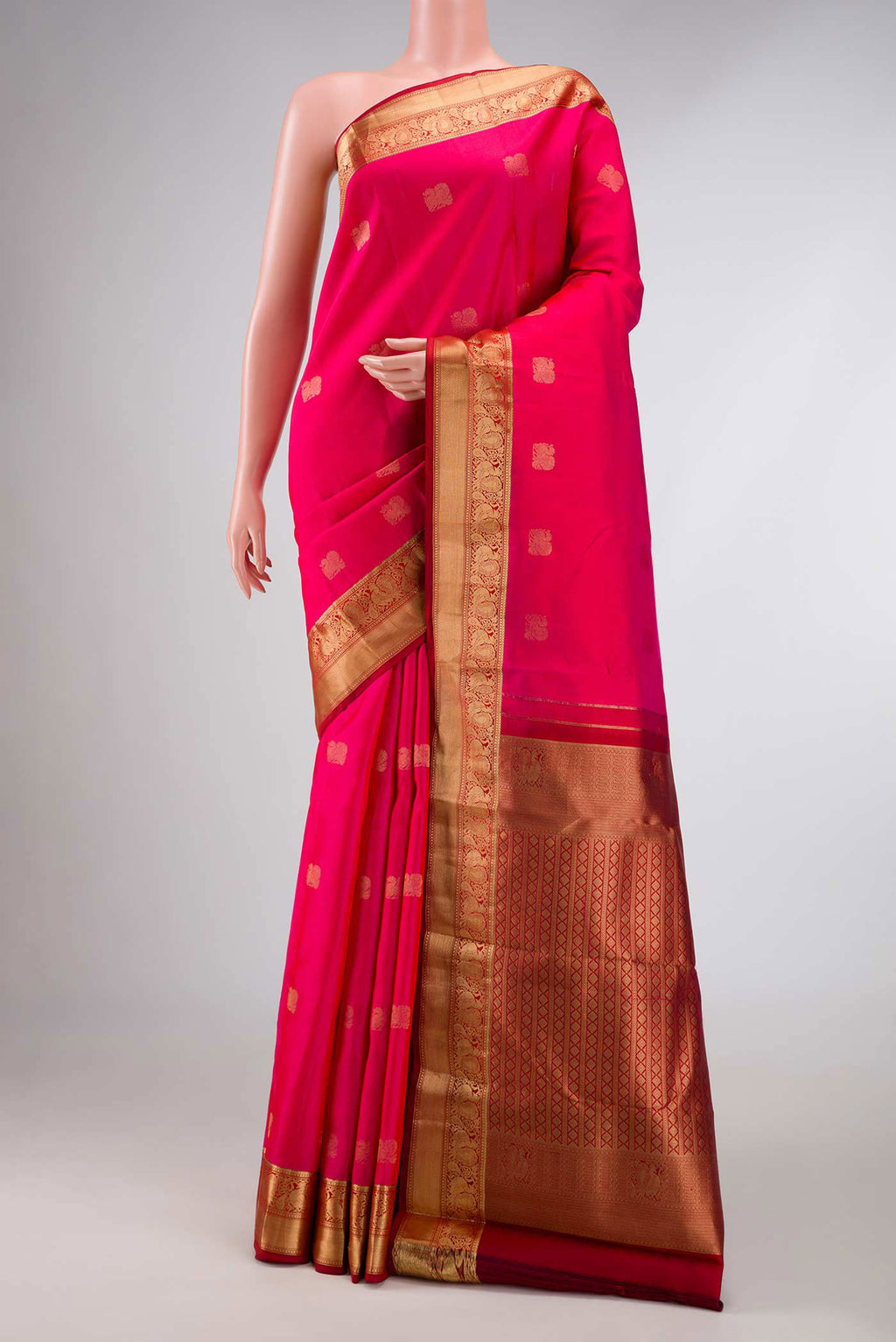 Pink with Orange Color Kanchipuram Silk Saree with Zari Butta on the body and Zari Border displayed on a mannequin
