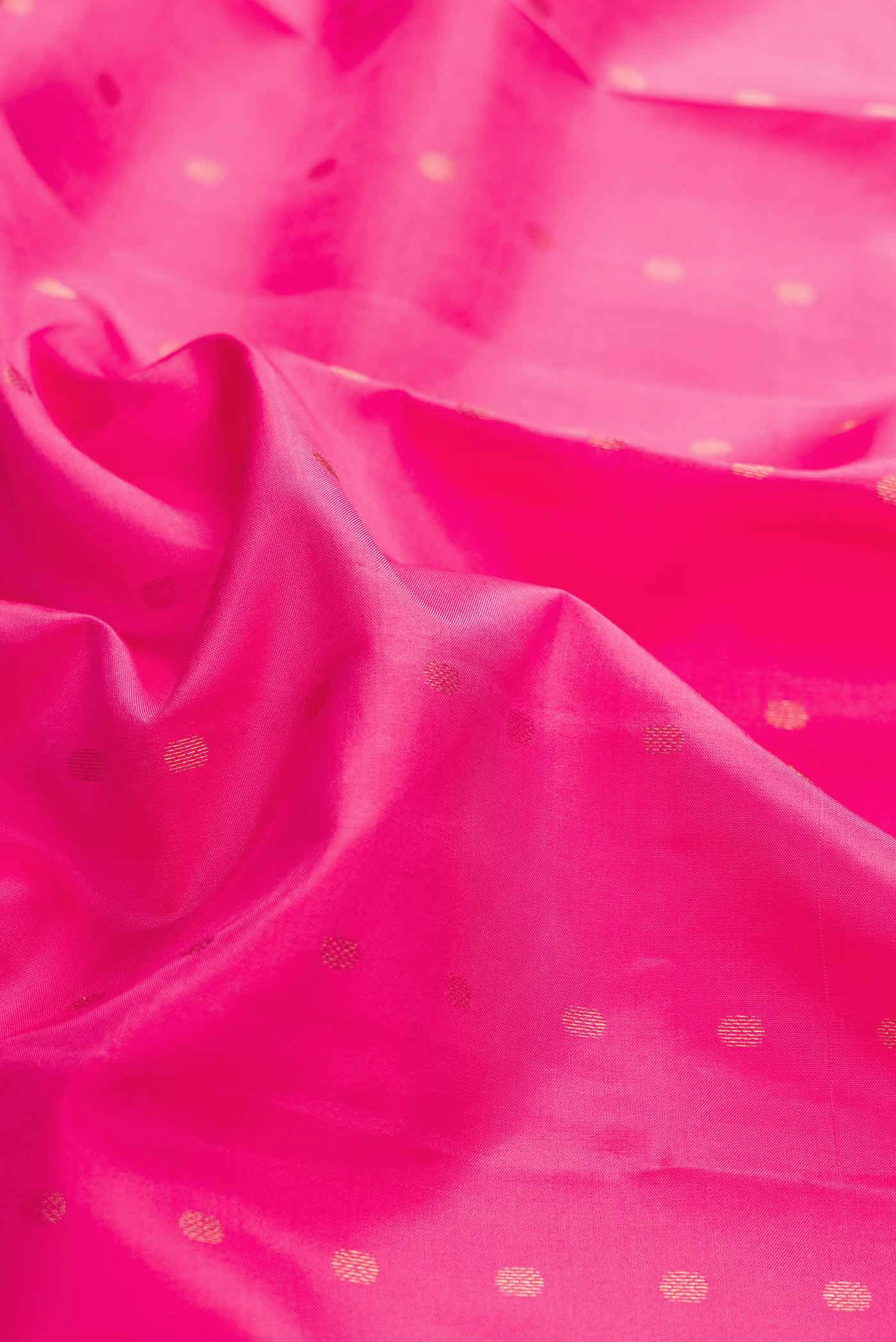 Close up of Pink Dual Tone Kanchipuram Silk Saree with Zari Butta on the body and Zari Border displaying folds