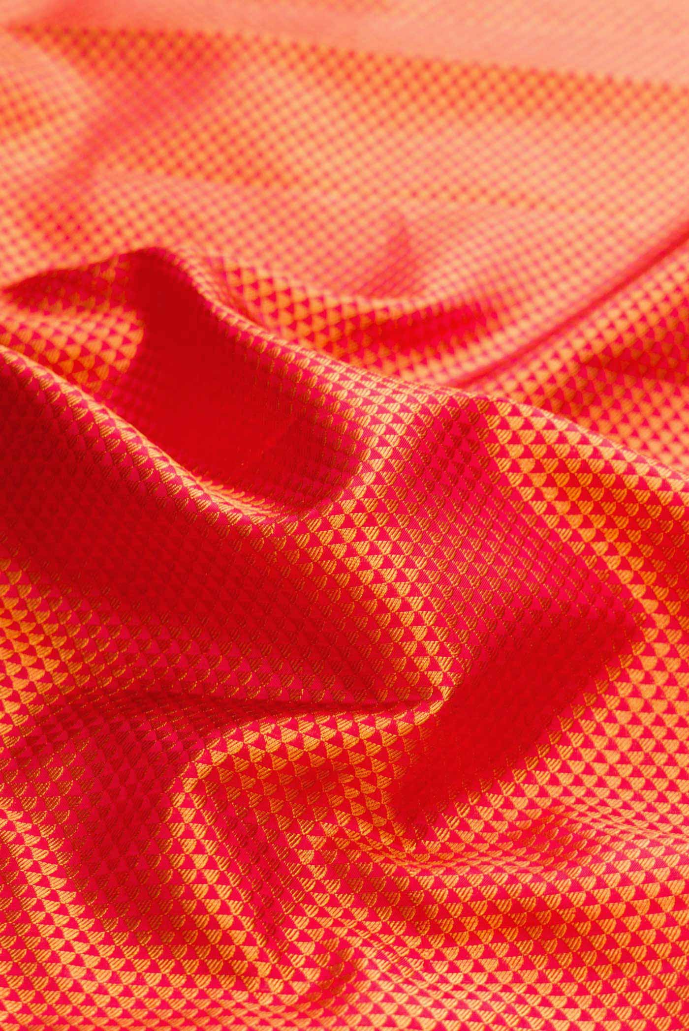Close up of Red Dual Tone Kanchipuram Silk Saree with Zari Brocade on the body and Zari Border displaying folds