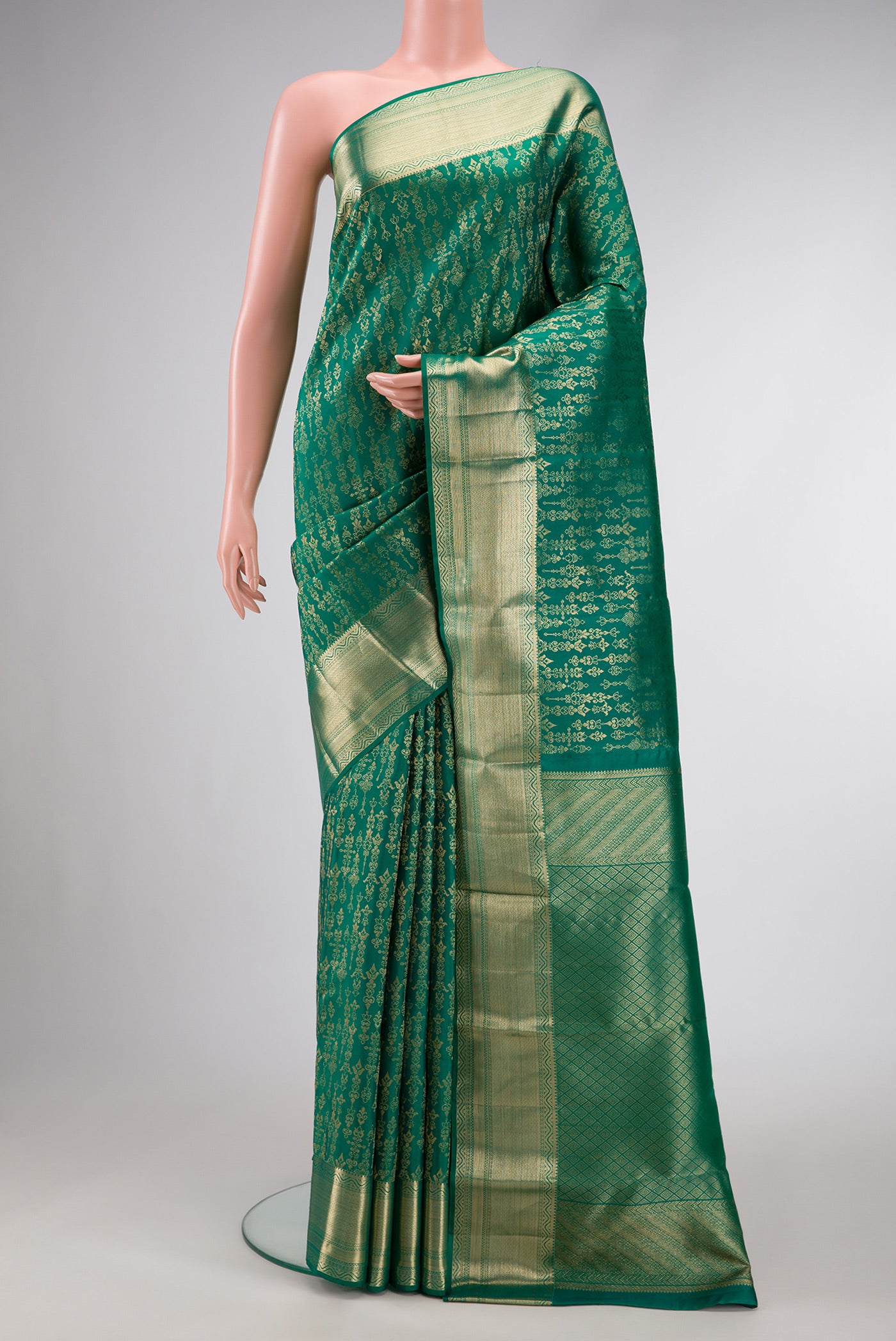 Green Dual Tone Kanchipuram Silk Saree with Zari Butta on the body and Zari Border.  displayed on a mannequin