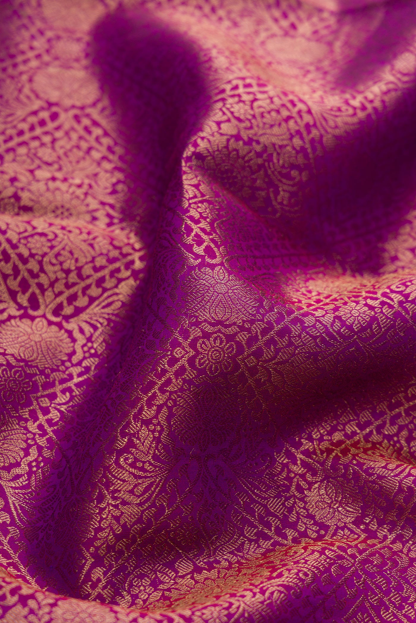 Close up of Purple Dual Tone Kanchipuram Silk Saree with Zari Brocade on the body and Zari Border.  displaying folds