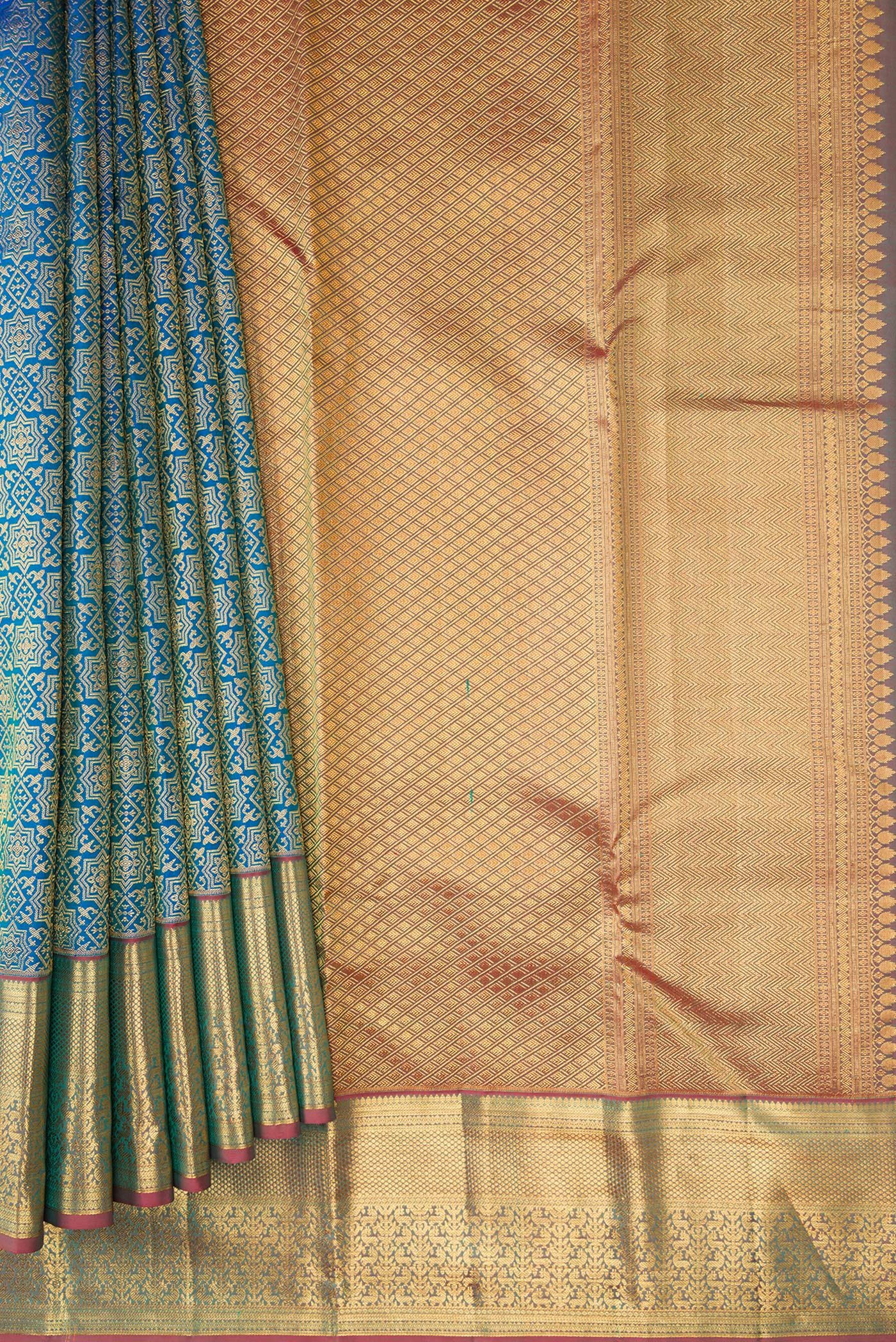 Pleats and pallu of Peacock Blue Dual Tone Kanchipuram Silk Saree with Zari Brocade on the body and Zari Border. 