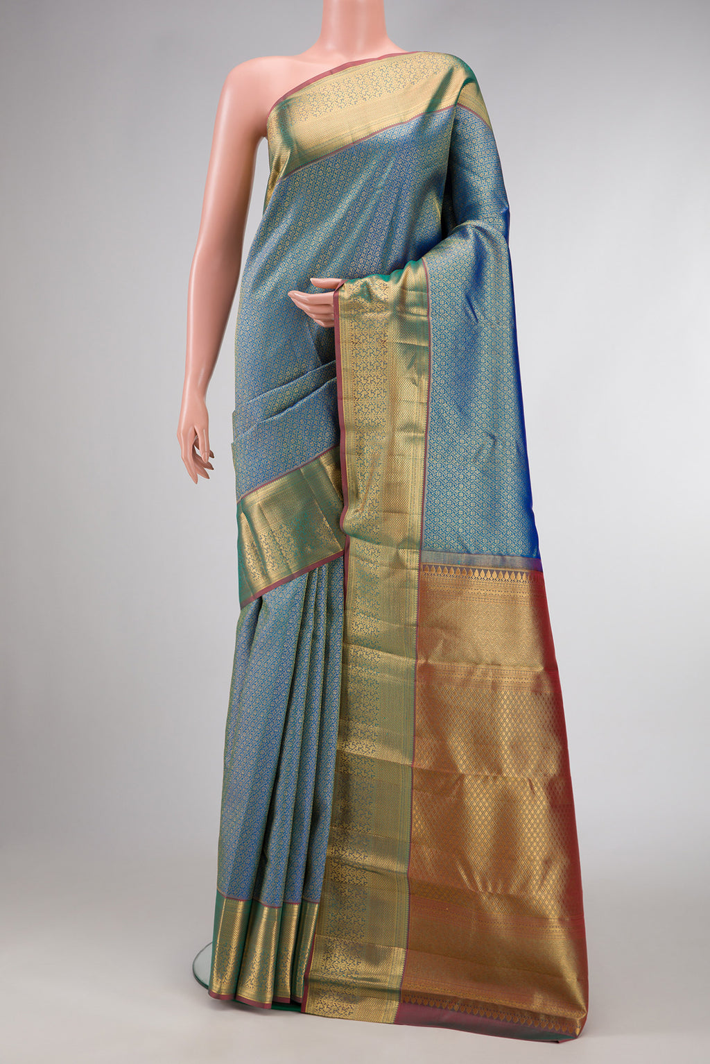 Peacock Blue Dual Tone Kanchipuram Silk Saree with Zari Brocade on the body and Zari Border.  displayed on a mannequin