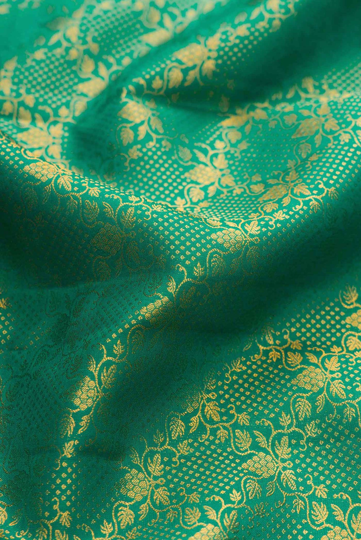 Close up of Green Dual Tone Kanchipuram Silk Saree with Zari Brocade on the body and Zari Border displaying folds