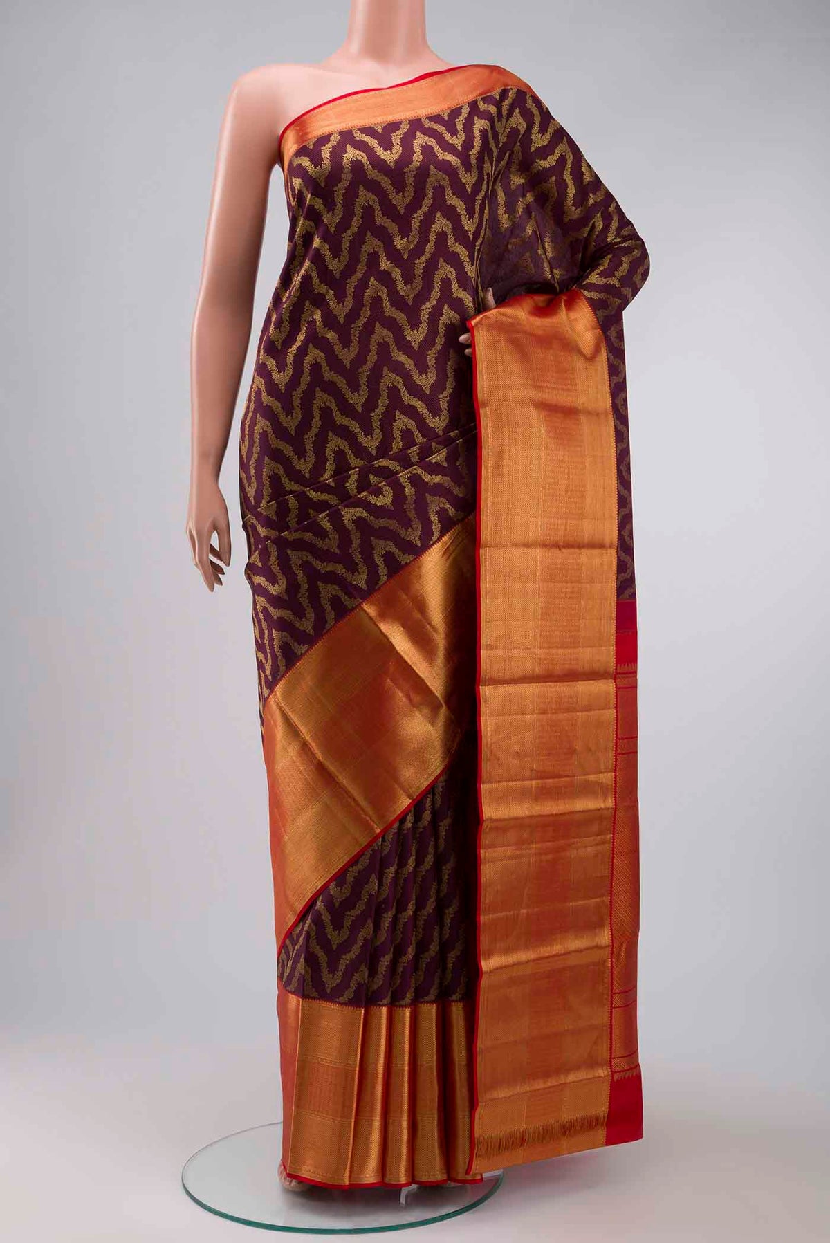 Burgundy Kanchipuram Silk Saree with Zari Brocade on the body and Zari Border displayed on a mannequin