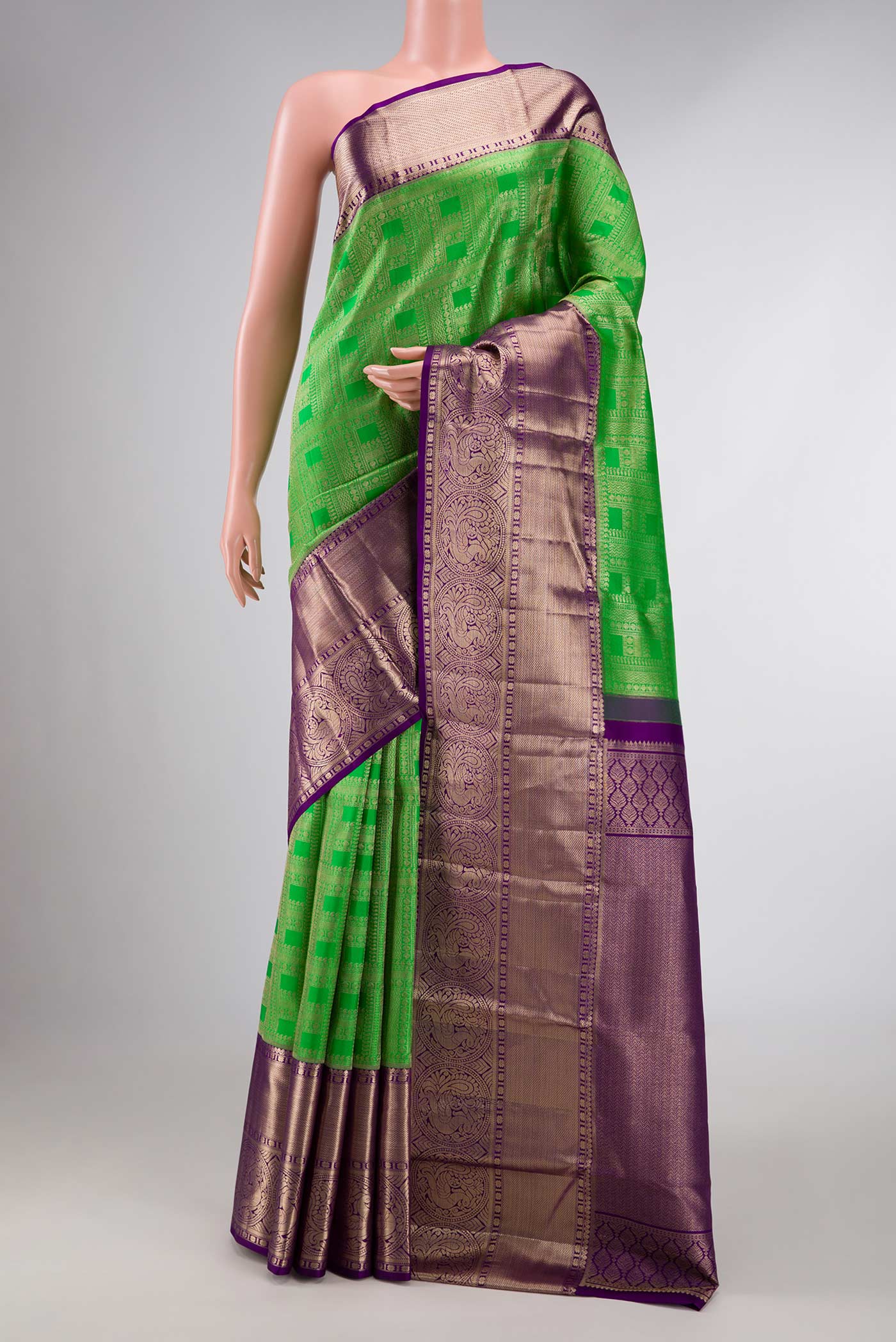Green Dual Tone Kanchipuram Silk Saree with Zari Brocade on the body and Zari Border displayed on a mannequin