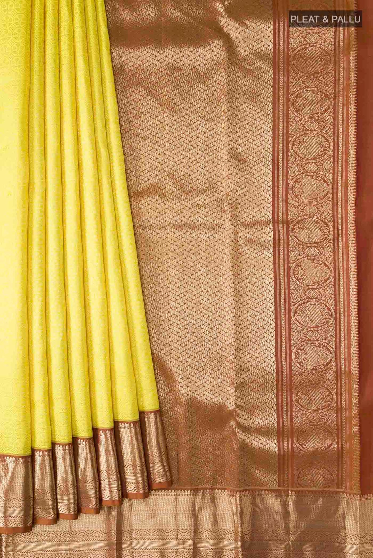 Pleats and pallu of Yellow Kanchipuram Silk Saree with Zari Brocade on the body and Zari Border