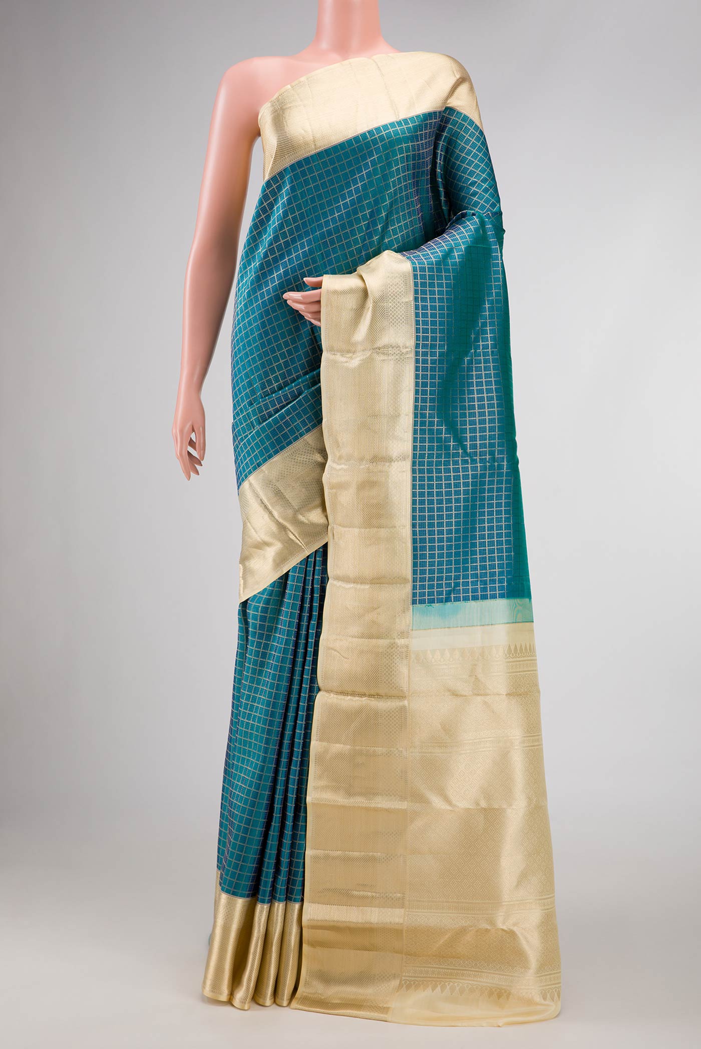 Peacock Blue Dual Tone Kanchipuram Silk Saree with Zari Brocade on the body and Zari Border.  displayed on a mannequin