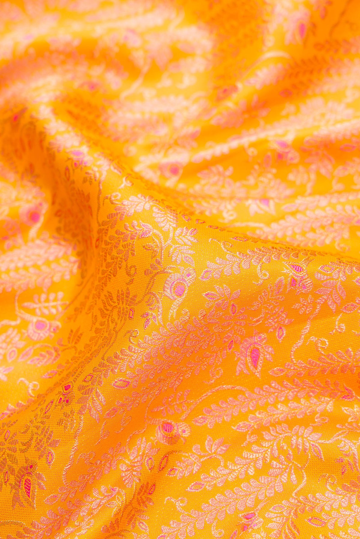 Close up of Yellow Dual Tone Kanchipuram Silk Saree with Zari Brocade on the body and Zari Border.  displaying folds