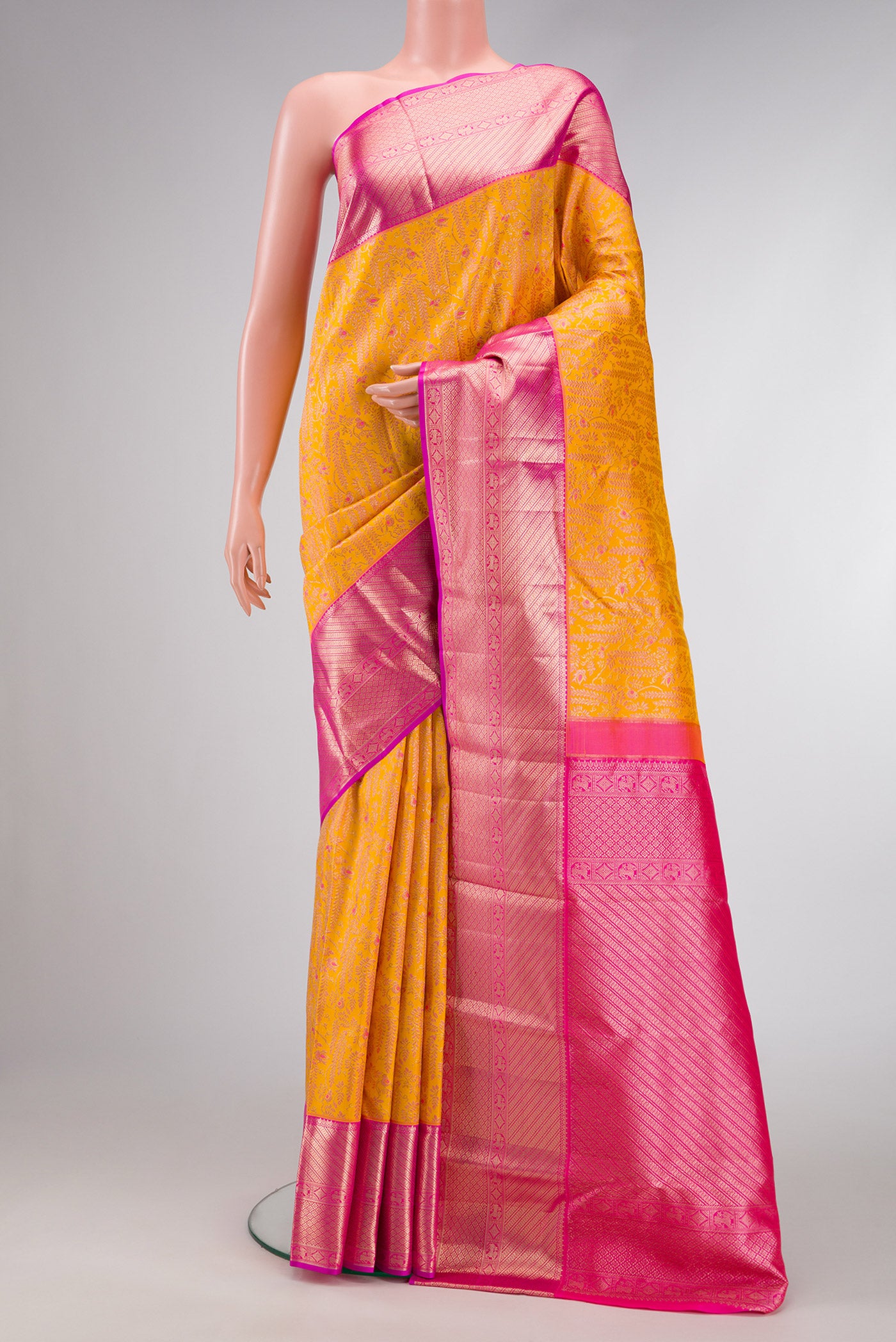 Yellow Dual Tone Kanchipuram Silk Saree with Zari Brocade on the body and Zari Border.  displayed on a mannequin