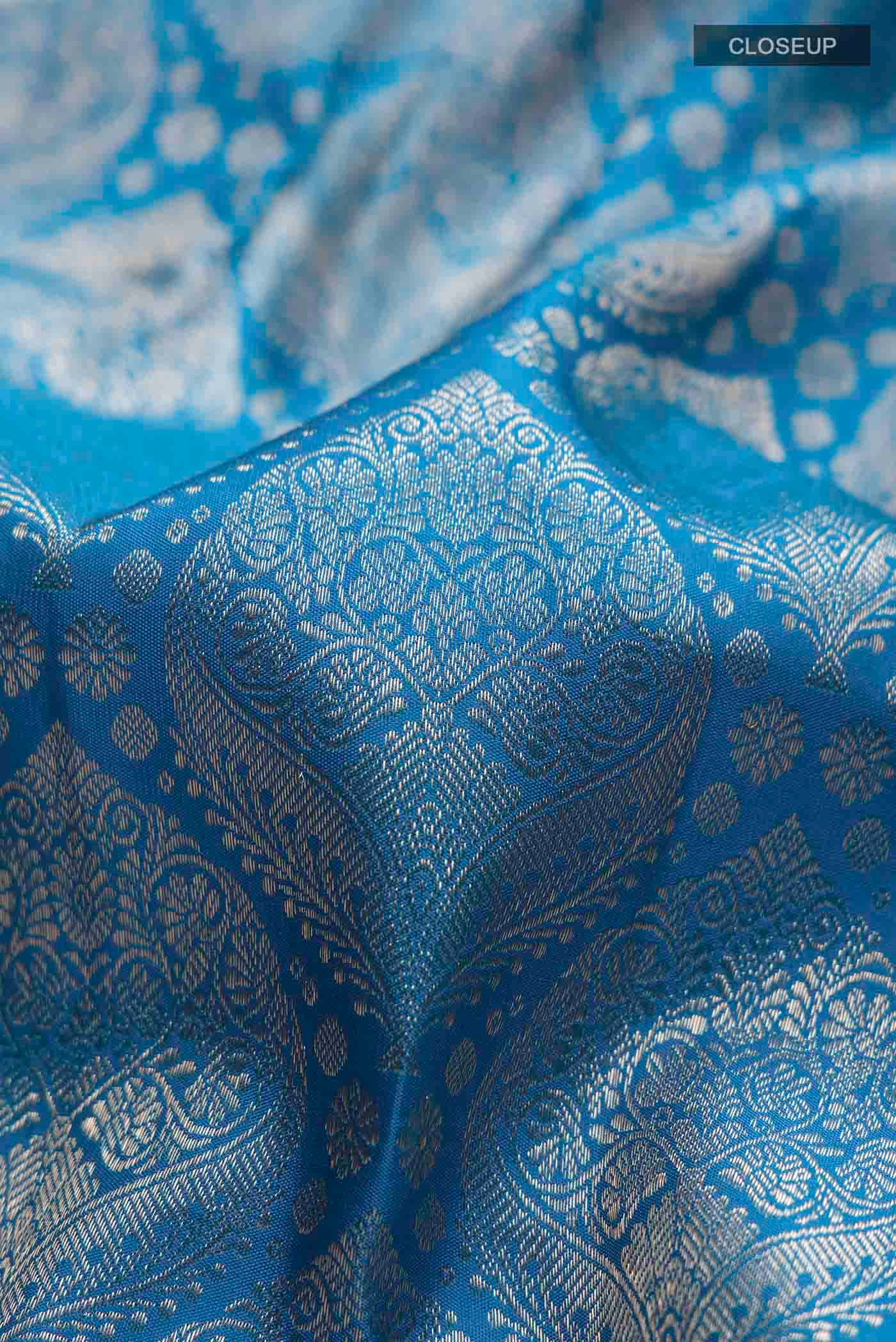 Close up of Blue Kanchipuram Silk Saree with Zari Brocade on the body and Zari Border displaying folds