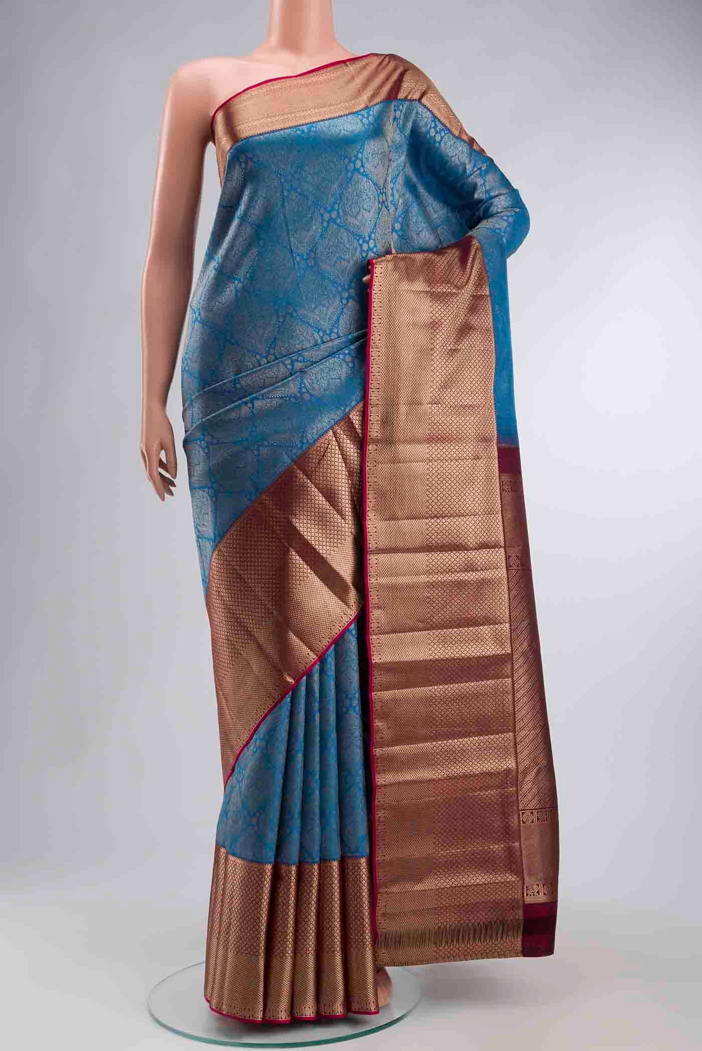 Blue Kanchipuram Silk Saree with Zari Brocade on the body and Zari Border displayed on a mannequin