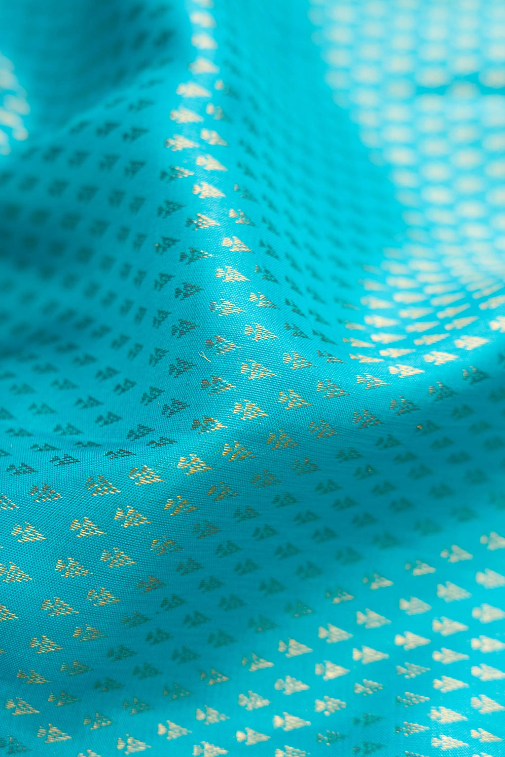 Close up of Sky Blue Dual Tone Kanchipuram Silk Saree with Zari Brocade on the body and Zari Border.  displaying folds