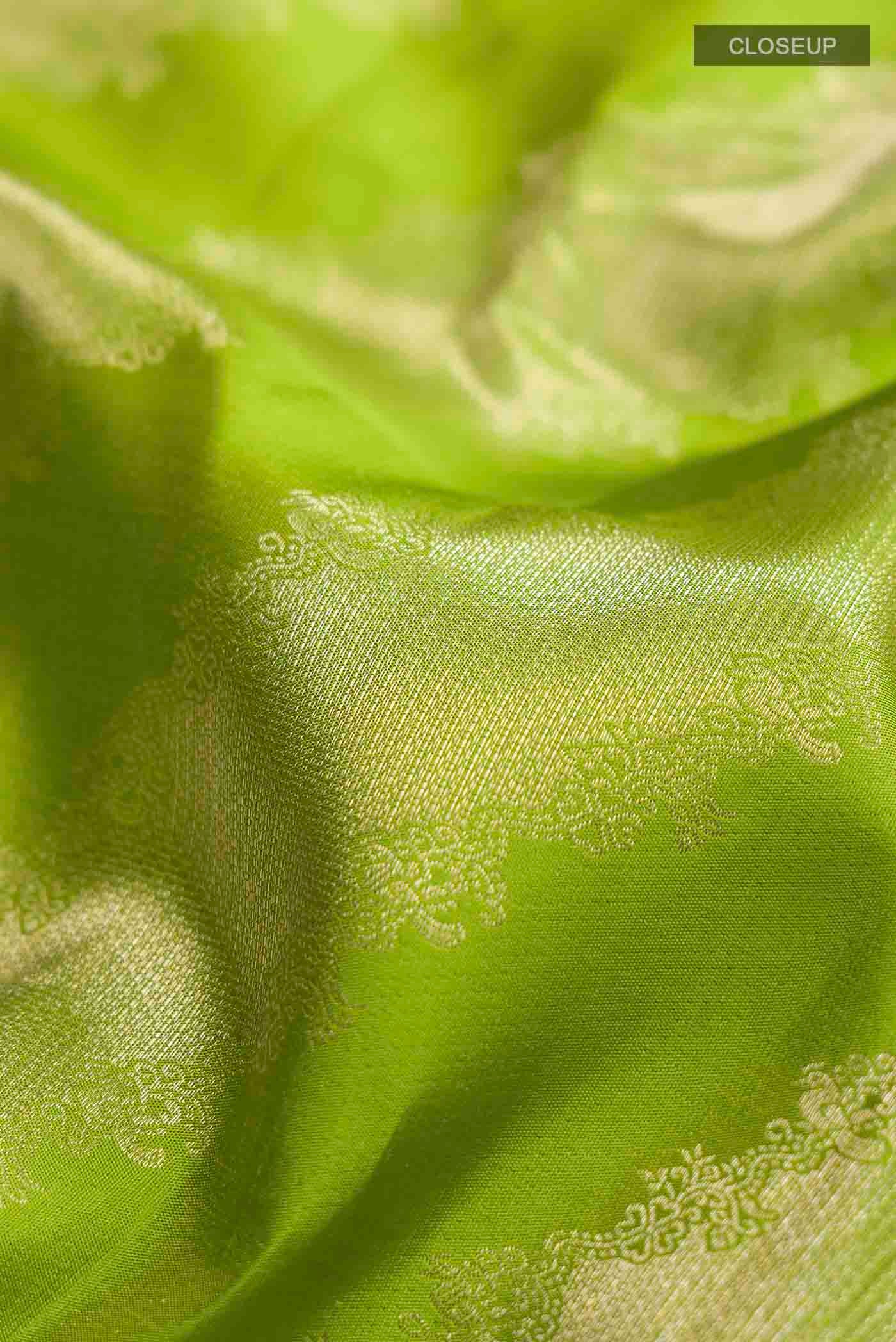 Close up of Green Kanchipuram Silk Saree with Zari Butta on the body and Zari Border displaying folds