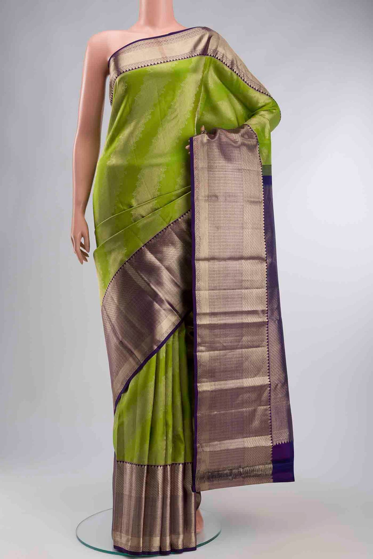 Green Kanchipuram Silk Saree with Zari Butta on the body and Zari Border displayed on a mannequin