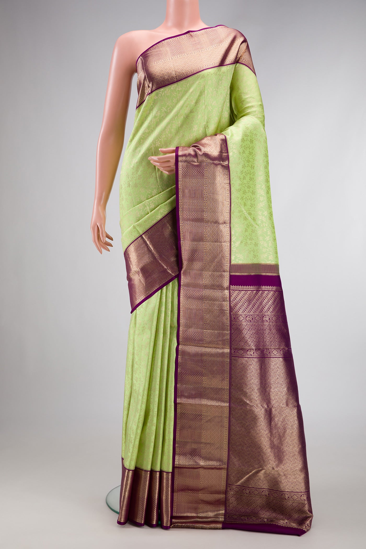 Parrot Green Dual Tone Kanchipuram Silk Saree with Zari Brocade on the body and Zari Border.  displayed on a mannequin