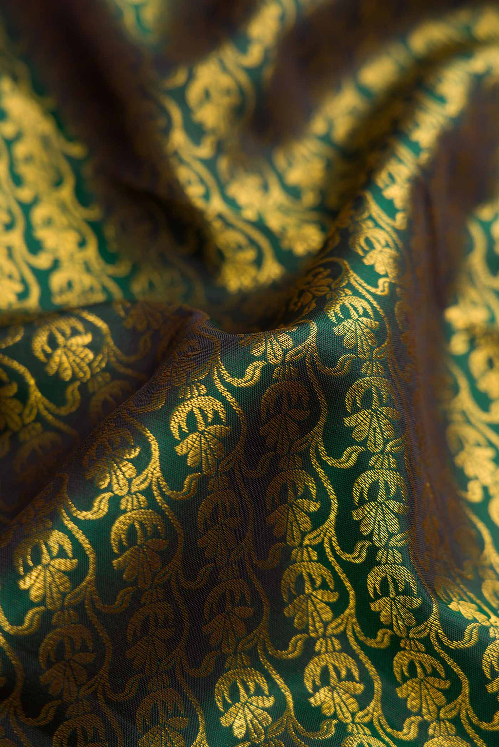 Close up of Bottle Green Dual Tone Kanchipuram Silk Saree with Zari Brocade on the body and Zari Border.  displaying folds