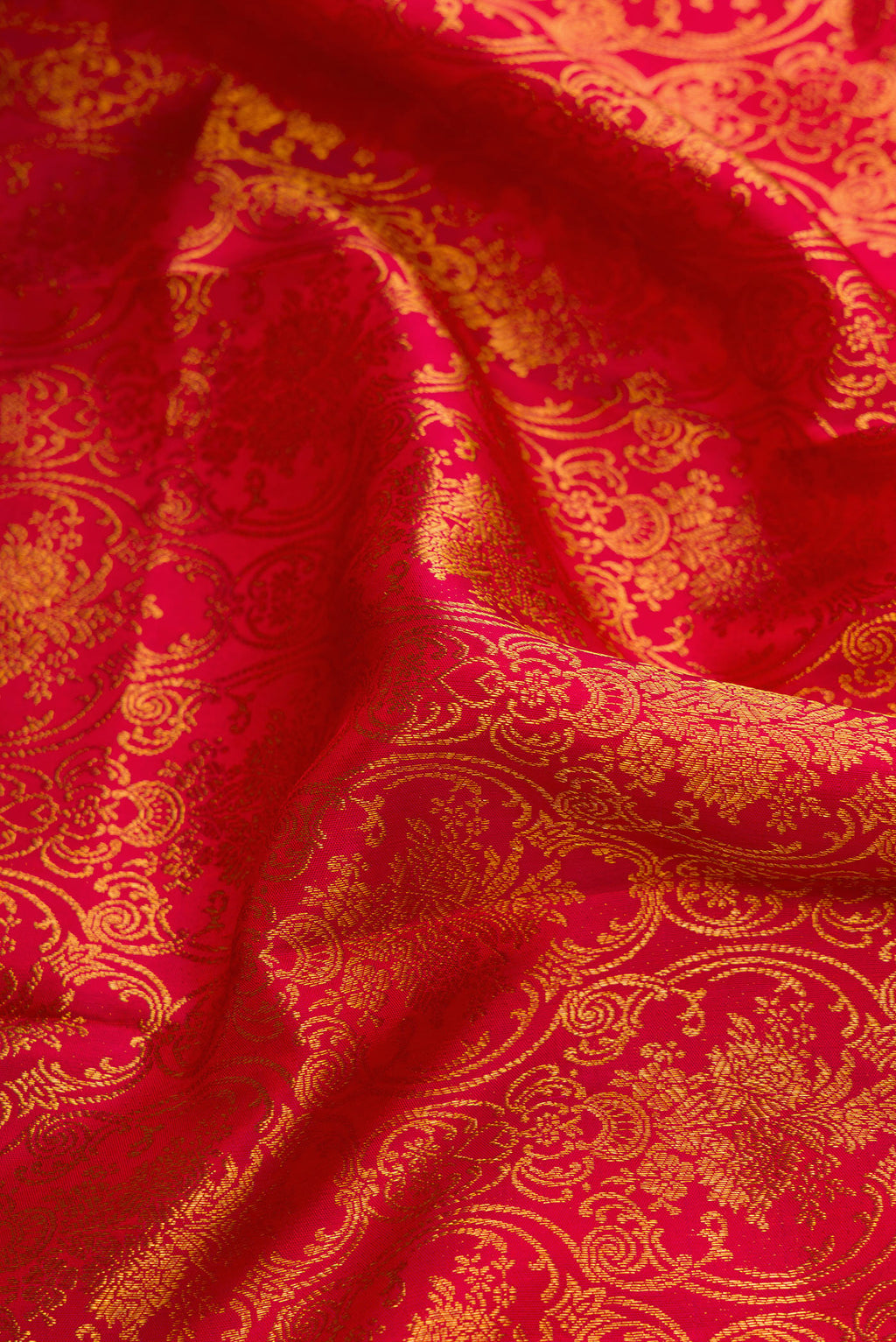 Close up of Red Dual Tone Kanchipuram Silk Saree with Zari Brocade on the body and Zari Border.  displaying folds