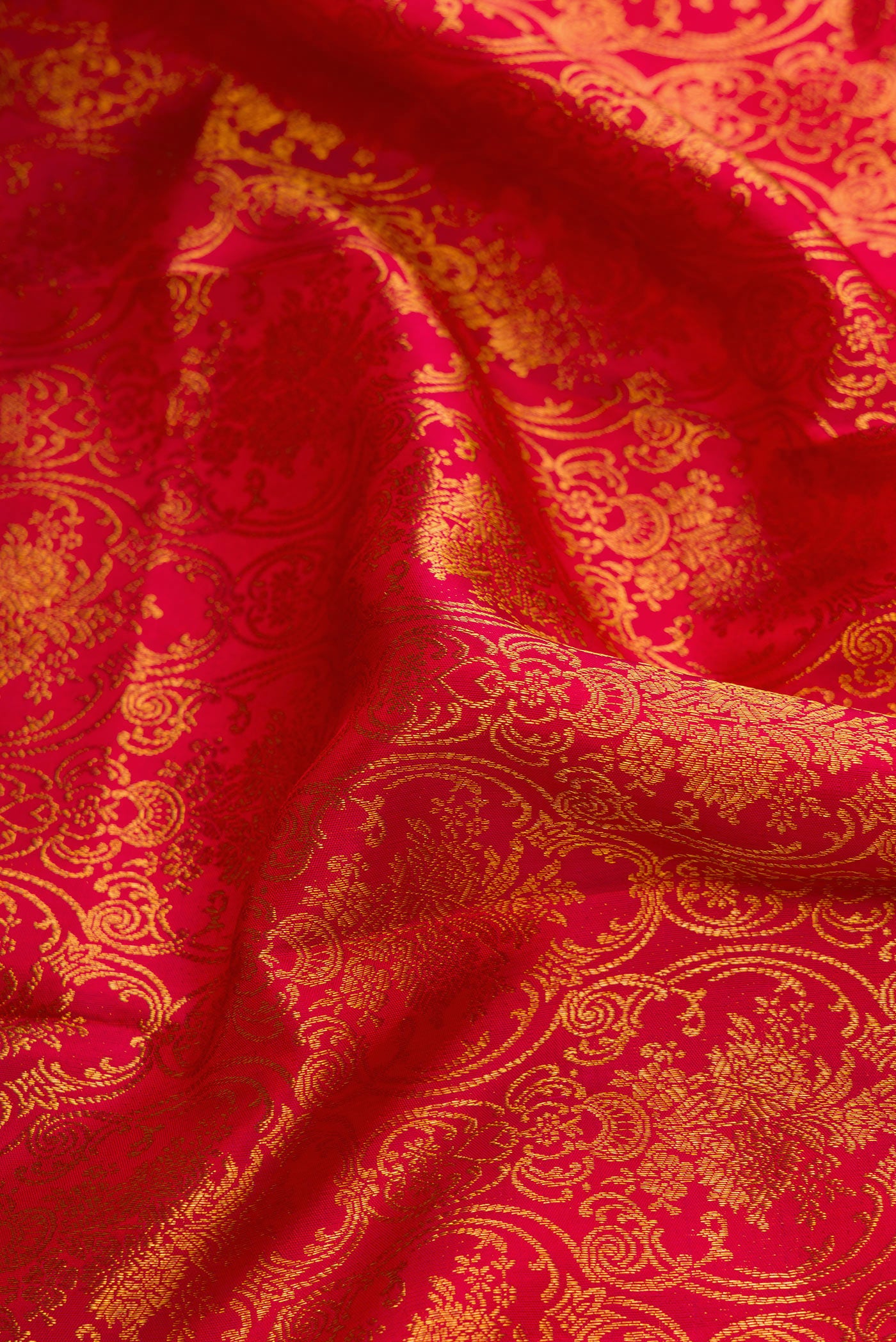 Close up of Red Dual Tone Kanchipuram Silk Saree with Zari Brocade on the body and Zari Border.  displaying folds