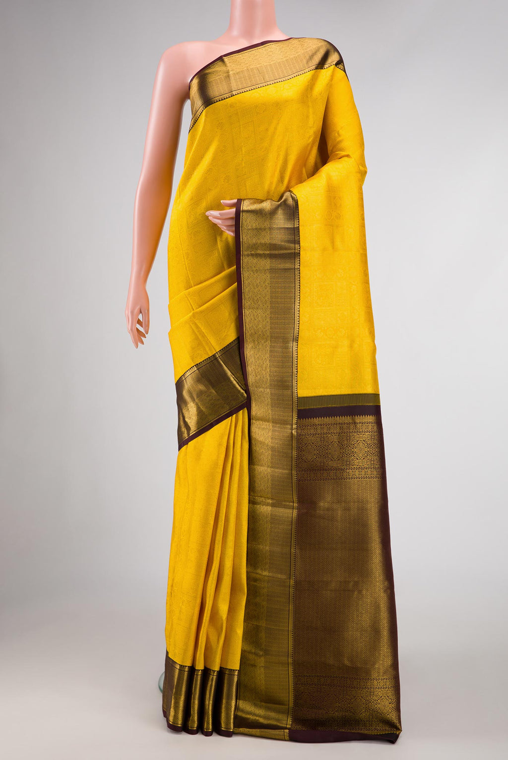 Yellow Dual Tone Kanjivaram Silk Saree with Zari Brocade on the body and Zari Border.  displayed on a mannequin