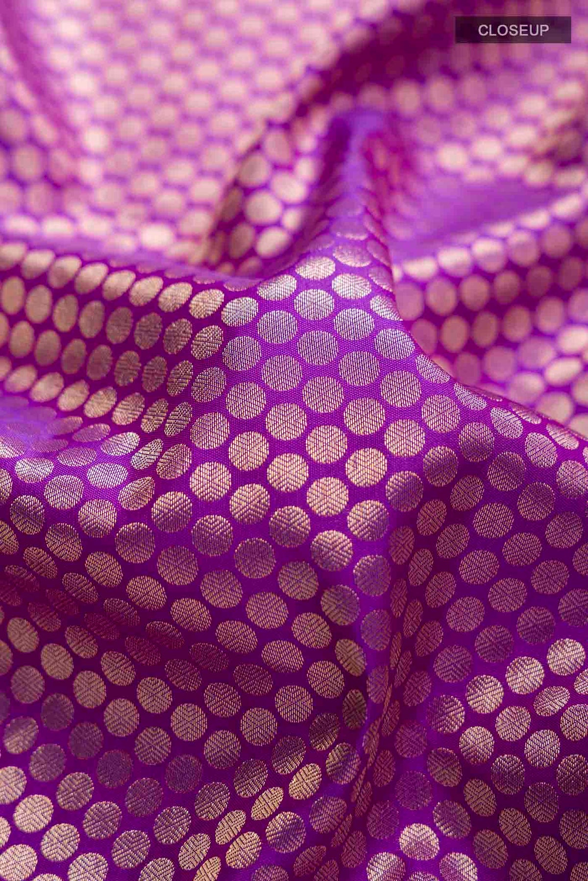 Close up of Violet Kanchipuram Silk Saree with Zari Brocade on the body and Zari Border displaying folds