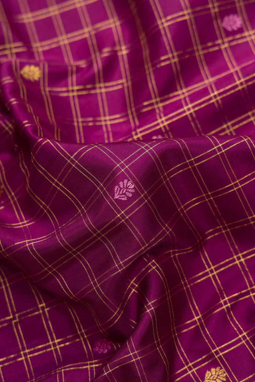 Close up of Pure Silk Pure Zari Burgundy Dual Tone Kanchipuram Saree with Checked design on the body and Zari Border.  displaying folds