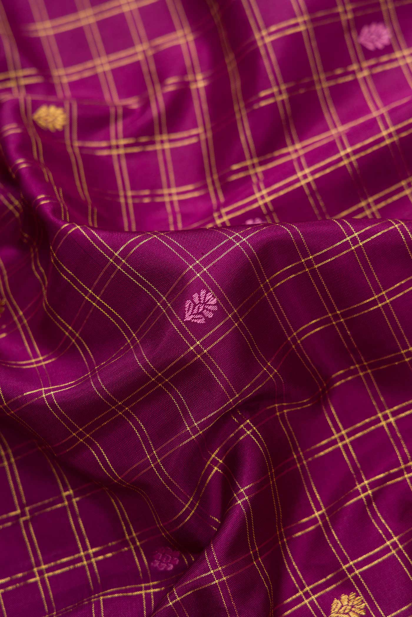 Close up of Pure Silk Pure Zari Burgundy Dual Tone Kanchipuram Saree with Checked design on the body and Zari Border.  displaying folds