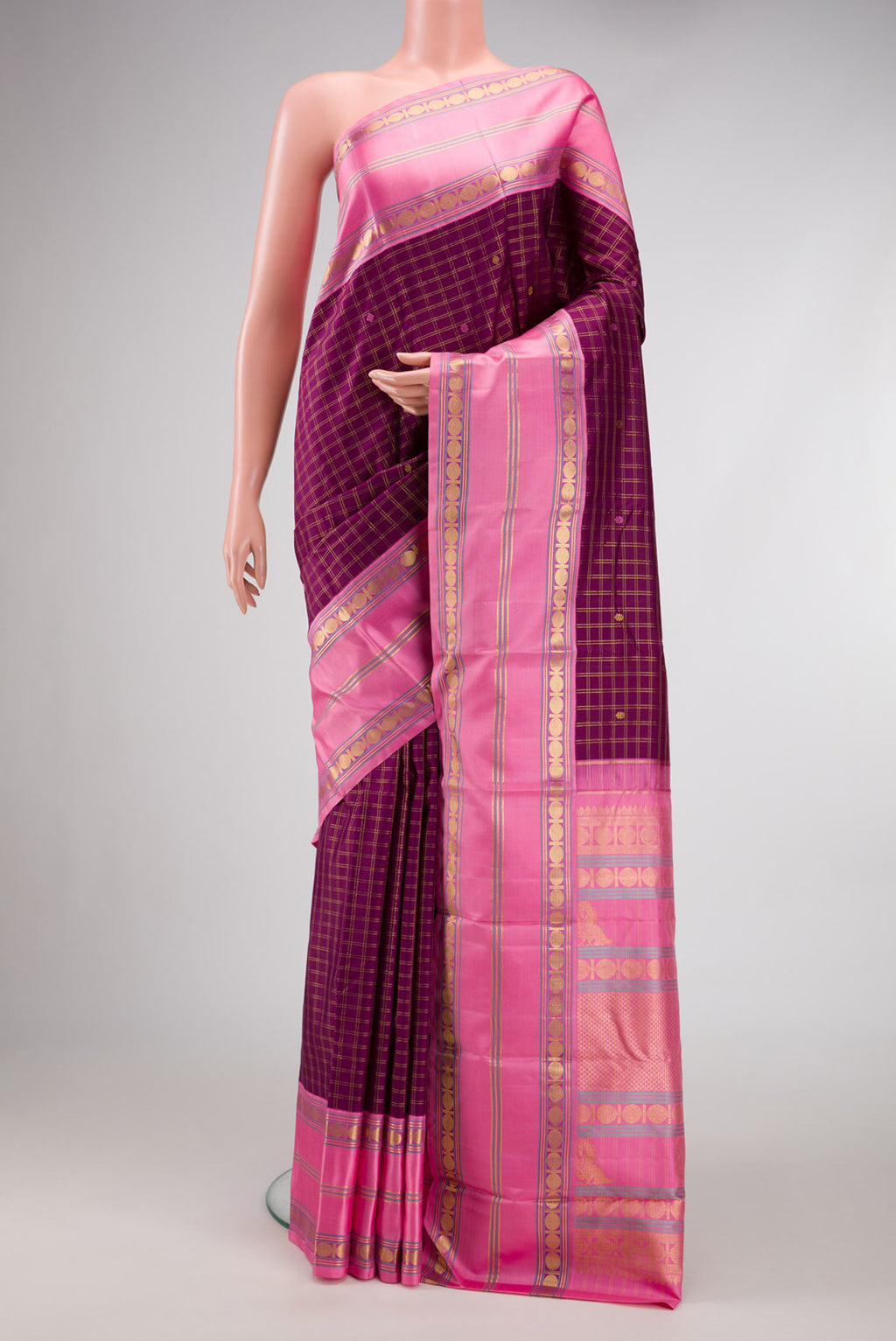 Pure Silk Pure Zari Burgundy Dual Tone Kanchipuram Saree with Checked design on the body and Zari Border.  displayed on a mannequin