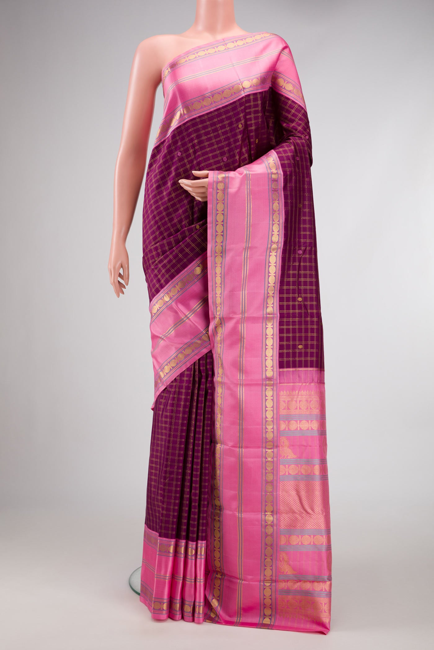 Pure Silk Pure Zari Burgundy Dual Tone Kanchipuram Saree with Checked design on the body and Zari Border.  displayed on a mannequin