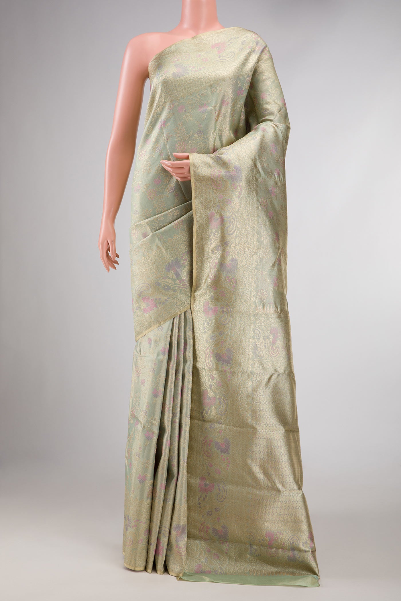Pista Green Dual Tone Kanchipuram Silk Saree with Zari Brocade on the body and Zari And Thread Border displayed on a mannequin