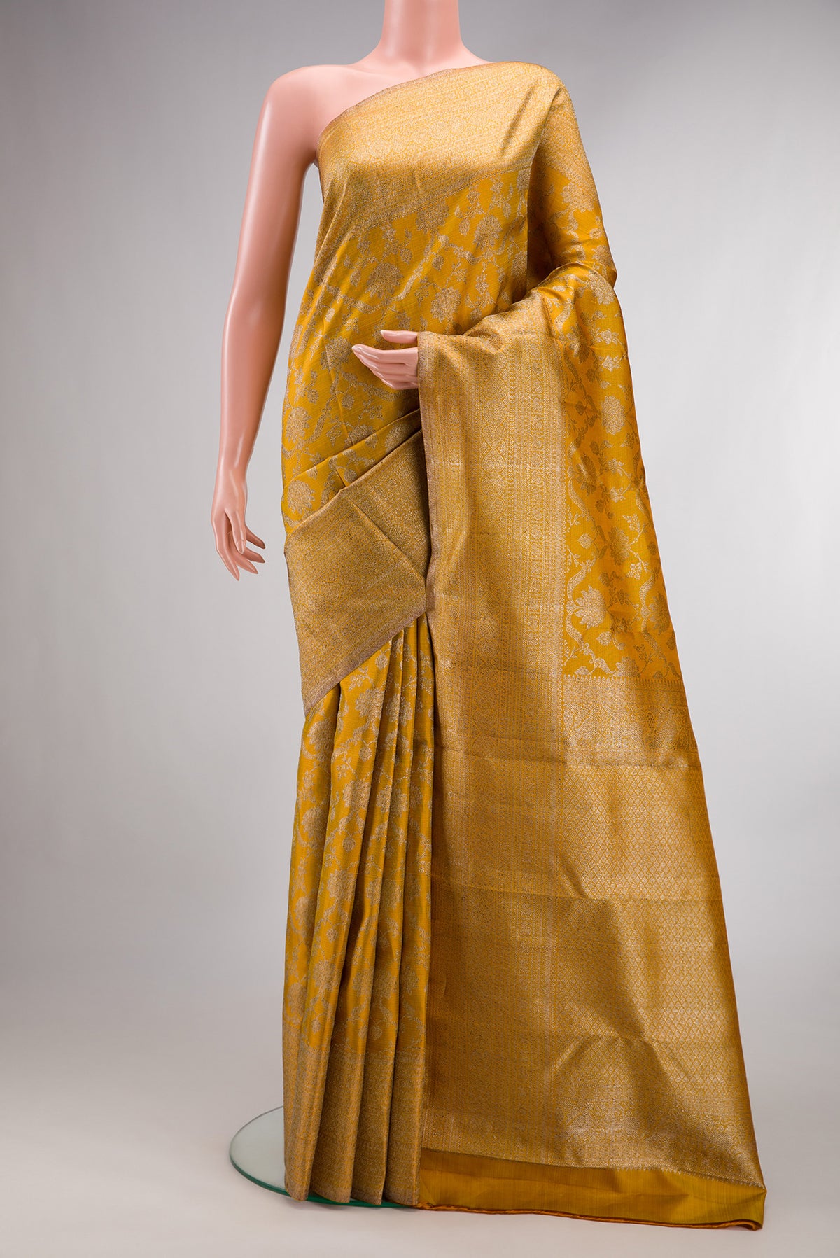 Pure Silk Mustard Kanchipuram Saree with Zari Brocade on the body and Zari Border.  displayed on a mannequin