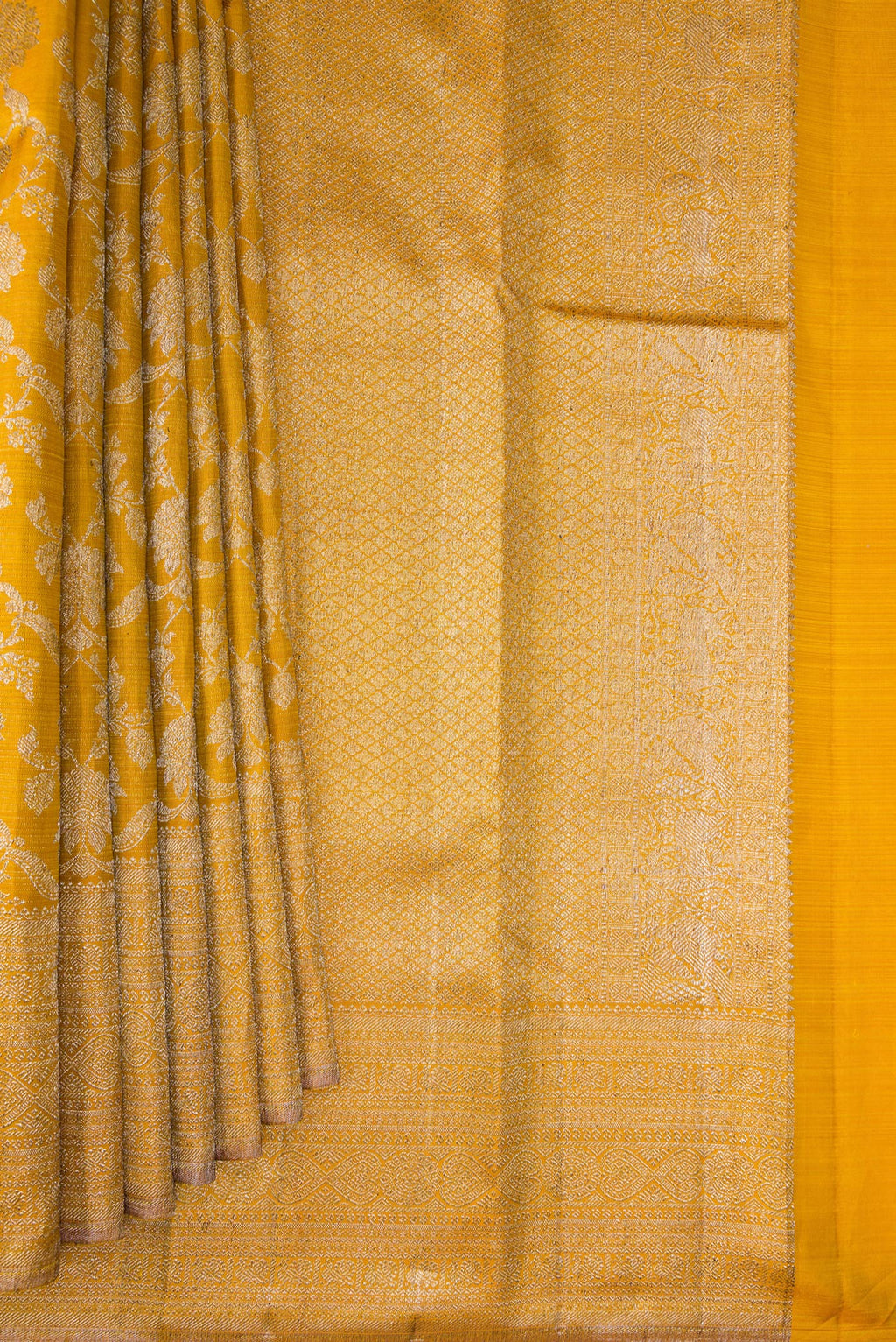 Pleats and pallu of Pure Silk Mustard Kanchipuram Saree with Zari Brocade on the body and Zari Border. 