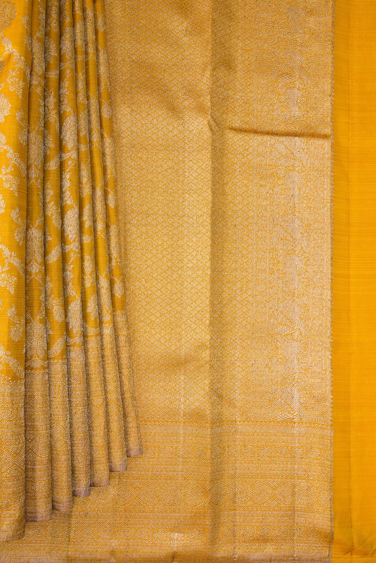 Pleats and pallu of Pure Silk Mustard Kanchipuram Saree with Zari Brocade on the body and Zari Border. 