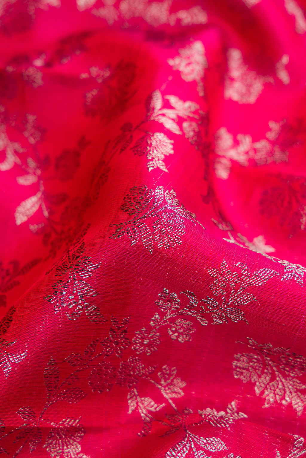 Close up of Dark Pink Dual Tone Kanchipuram Silk Saree with Zari Brocade on the body and Zari Border.  displaying folds