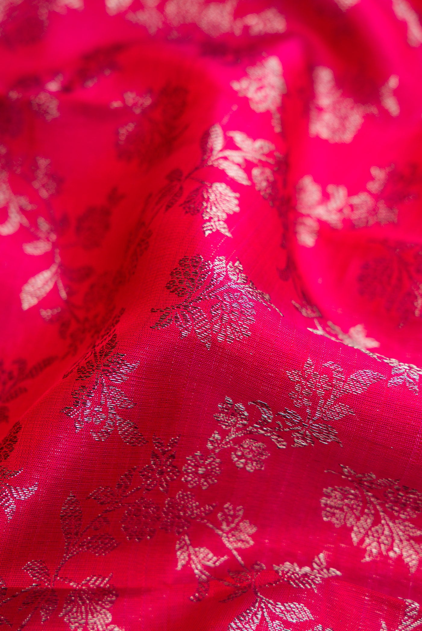 Close up of Dark Pink Dual Tone Kanchipuram Silk Saree with Zari Brocade on the body and Zari Border.  displaying folds