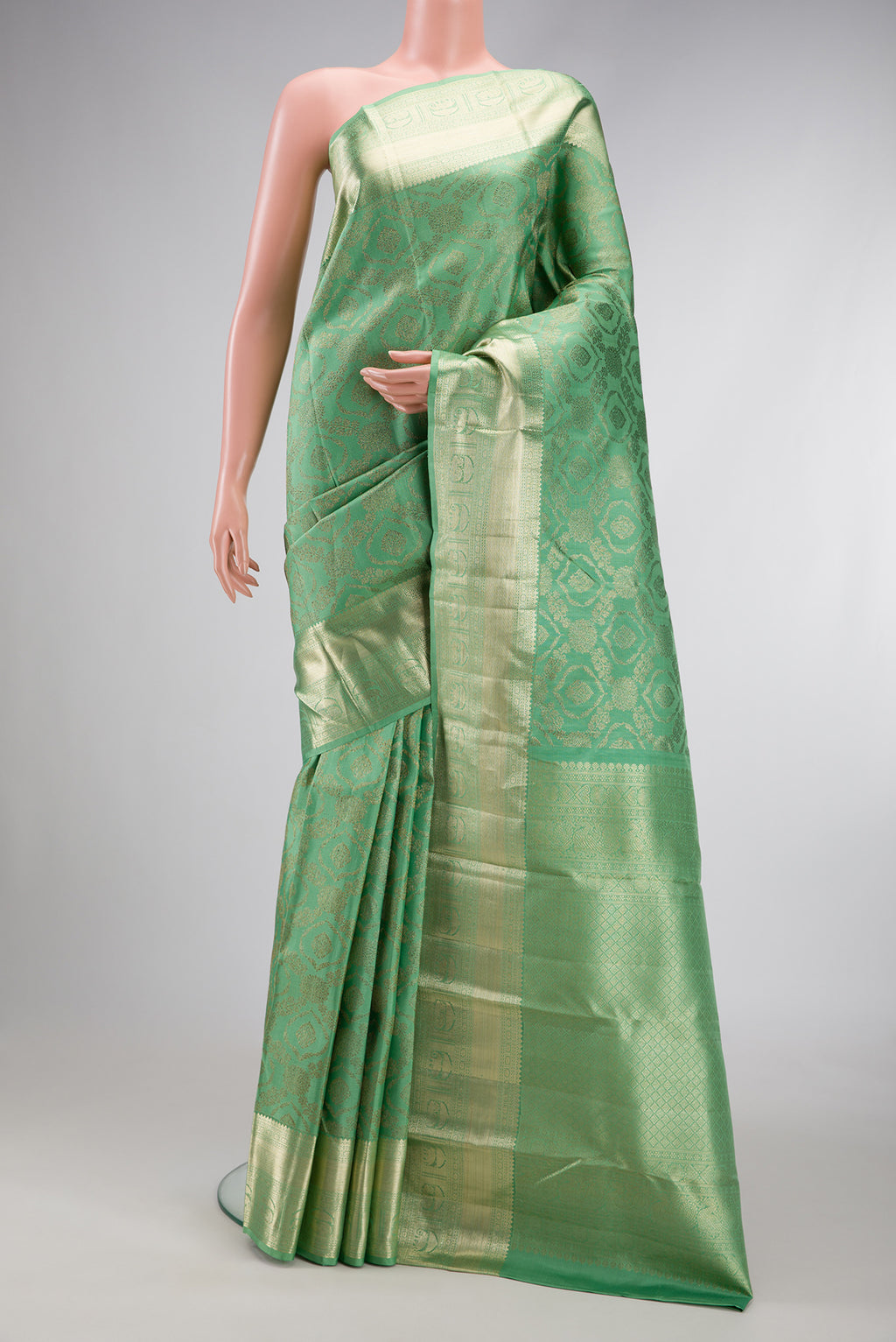 Green Dual Tone Kanchipuram Silk Saree with Zari Brocade on the body and Zari Border.  displayed on a mannequin