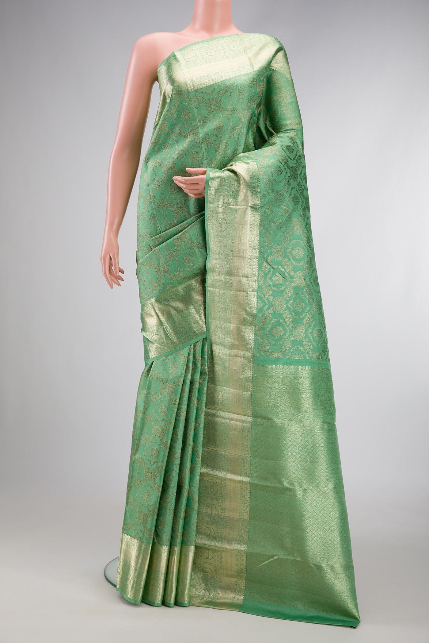 Green Dual Tone Kanchipuram Silk Saree with Zari Brocade on the body and Zari Border.  displayed on a mannequin