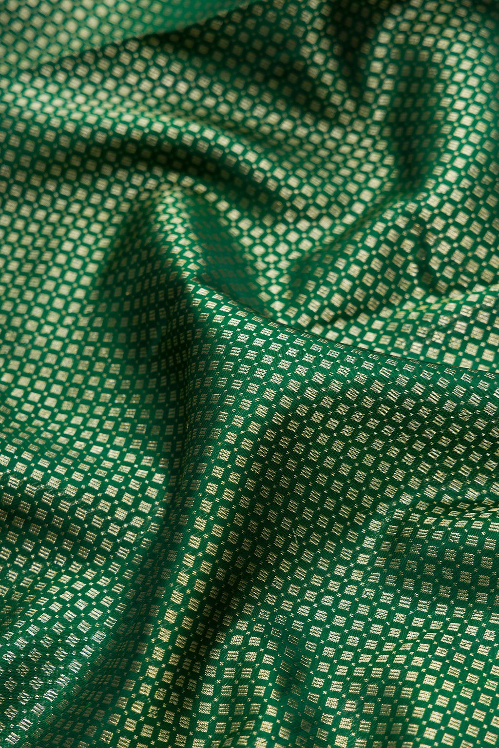 Close up of Bottle Green Dual Tone Kanchipuram Silk Saree with Zari Brocade on the body and Fancy Border.  displaying folds