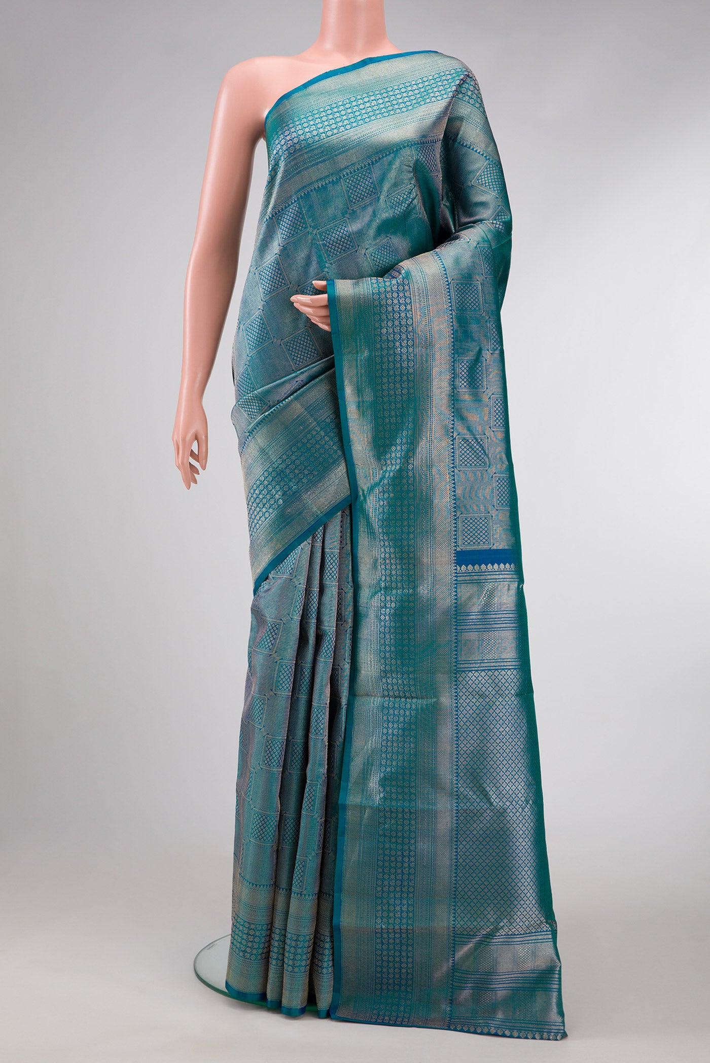 Peacock Blue Dual Tone Kanchipuram Silk Saree with Zari Brocade on the body and Zari Border.  displayed on a mannequin