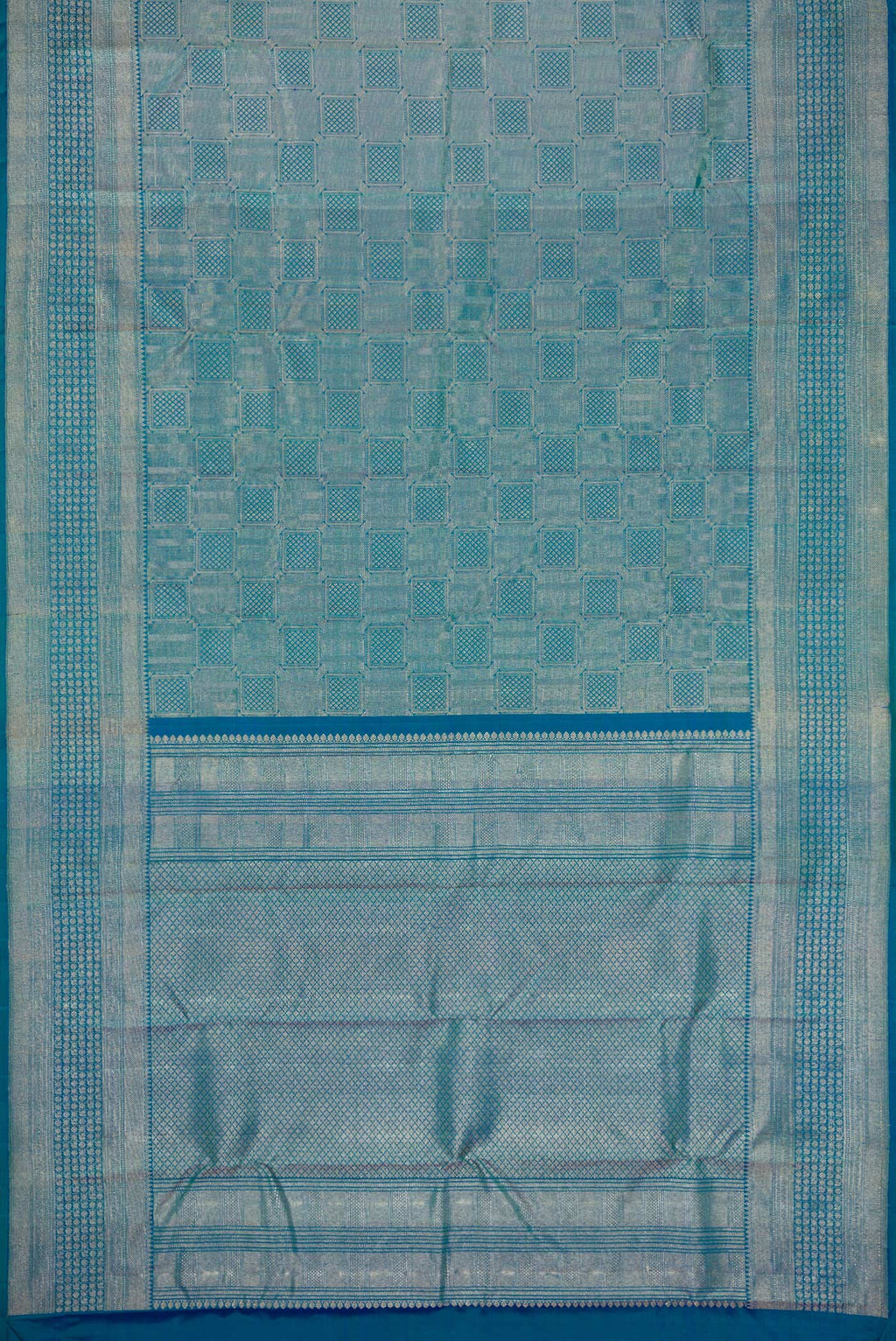 Flat view of Peacock Blue Dual Tone Kanchipuram Silk Saree with Zari Brocade on the body and Zari Border. 