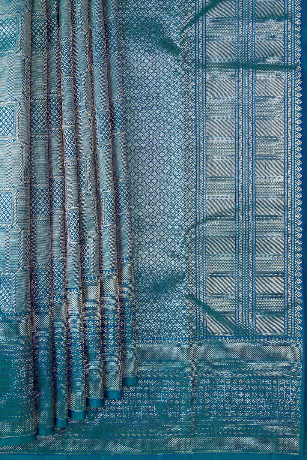 Pleats and pallu of Peacock Blue Dual Tone Kanchipuram Silk Saree with Zari Brocade on the body and Zari Border. 