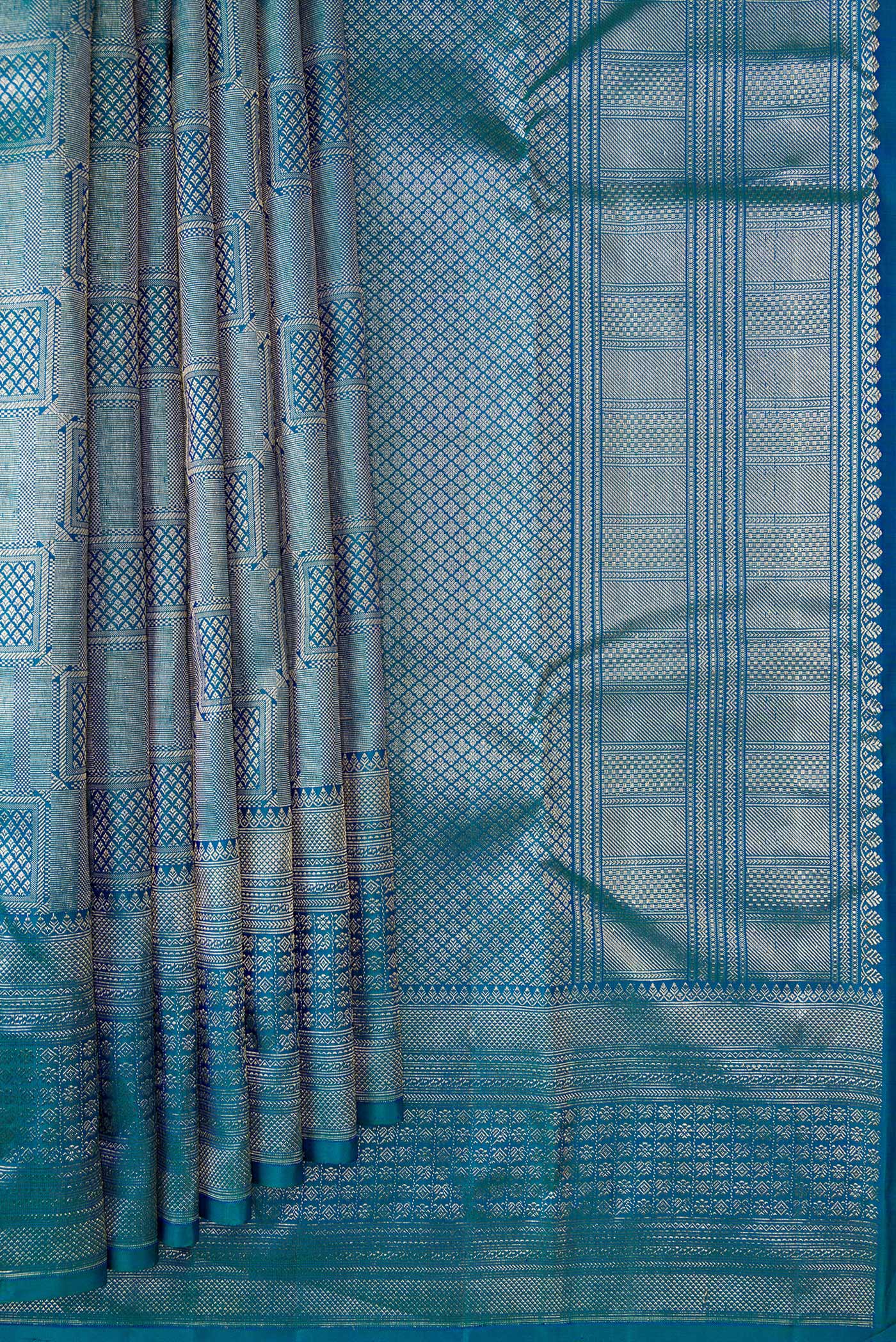 Pleats and pallu of Peacock Blue Dual Tone Kanchipuram Silk Saree with Zari Brocade on the body and Zari Border. 