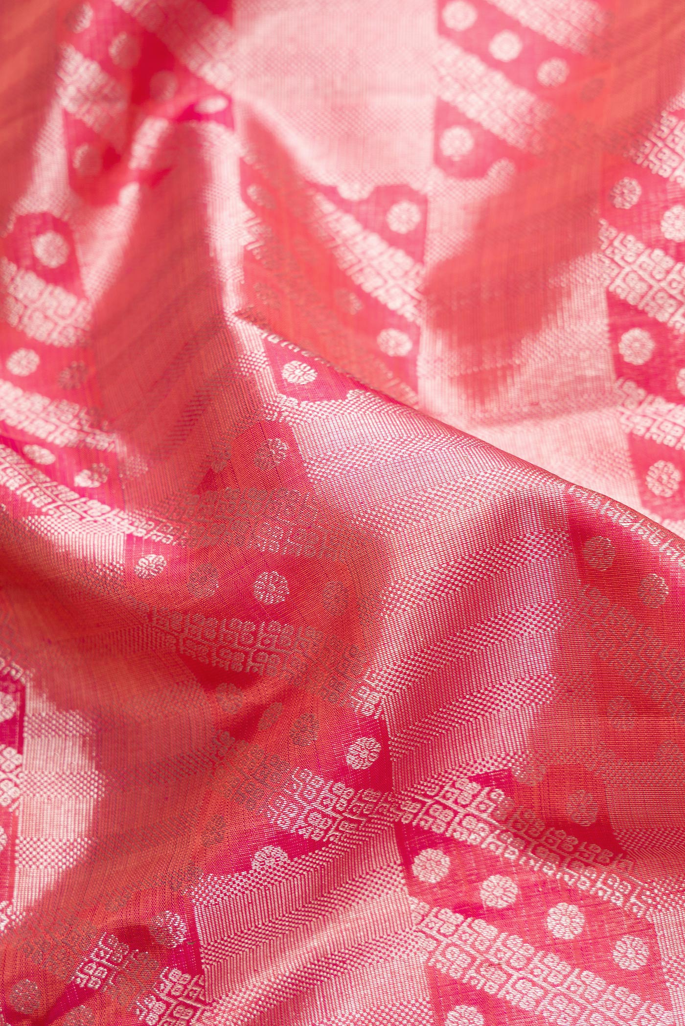 Close up of Pink Dual Tone Kanchipuram Silk Saree with Zari Brocade on the body and Zari Border.  displaying folds