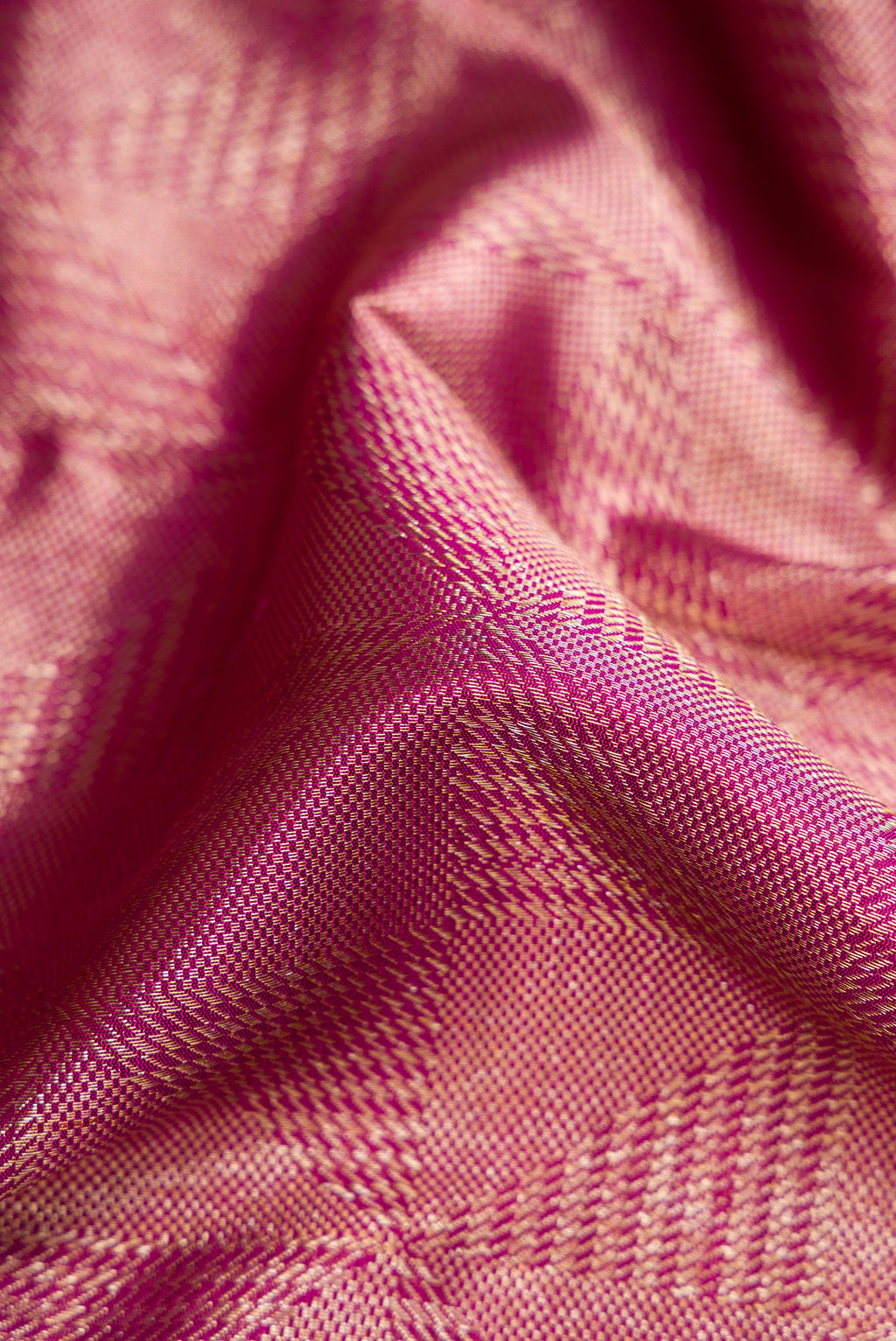 Close up of Magenta Dual Tone Kanchipuram Silk Saree with Zari Brocade on the body and Zari Border.  displaying folds