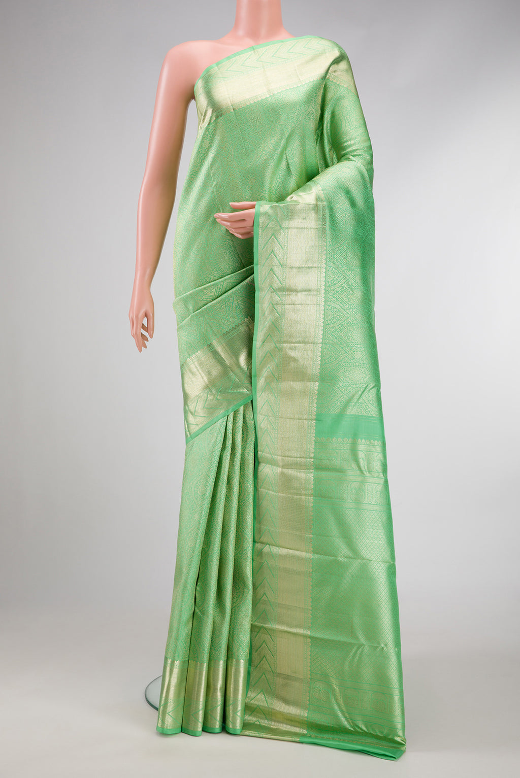 Light Green Dual Tone Kanchipuram Silk Saree with Zari Brocade on the body and Zari Border.  displayed on a mannequin