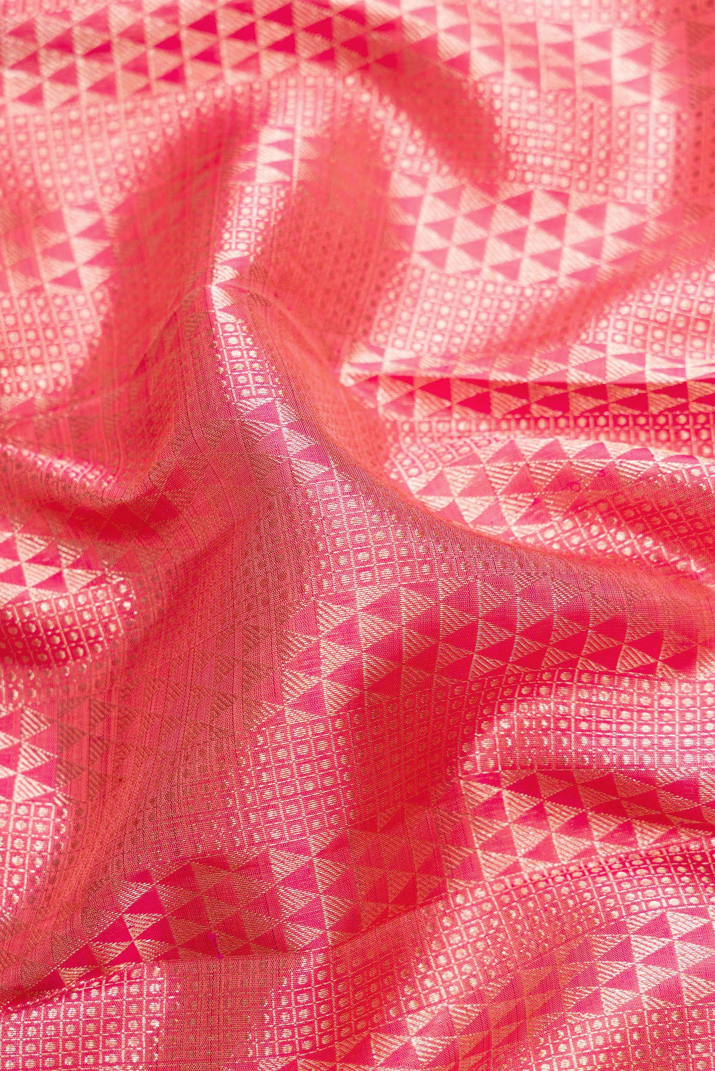 Close up of Pink Dual Tone Kanchipuram Silk Saree with Zari Brocade on the body and Zari Border.  displaying folds