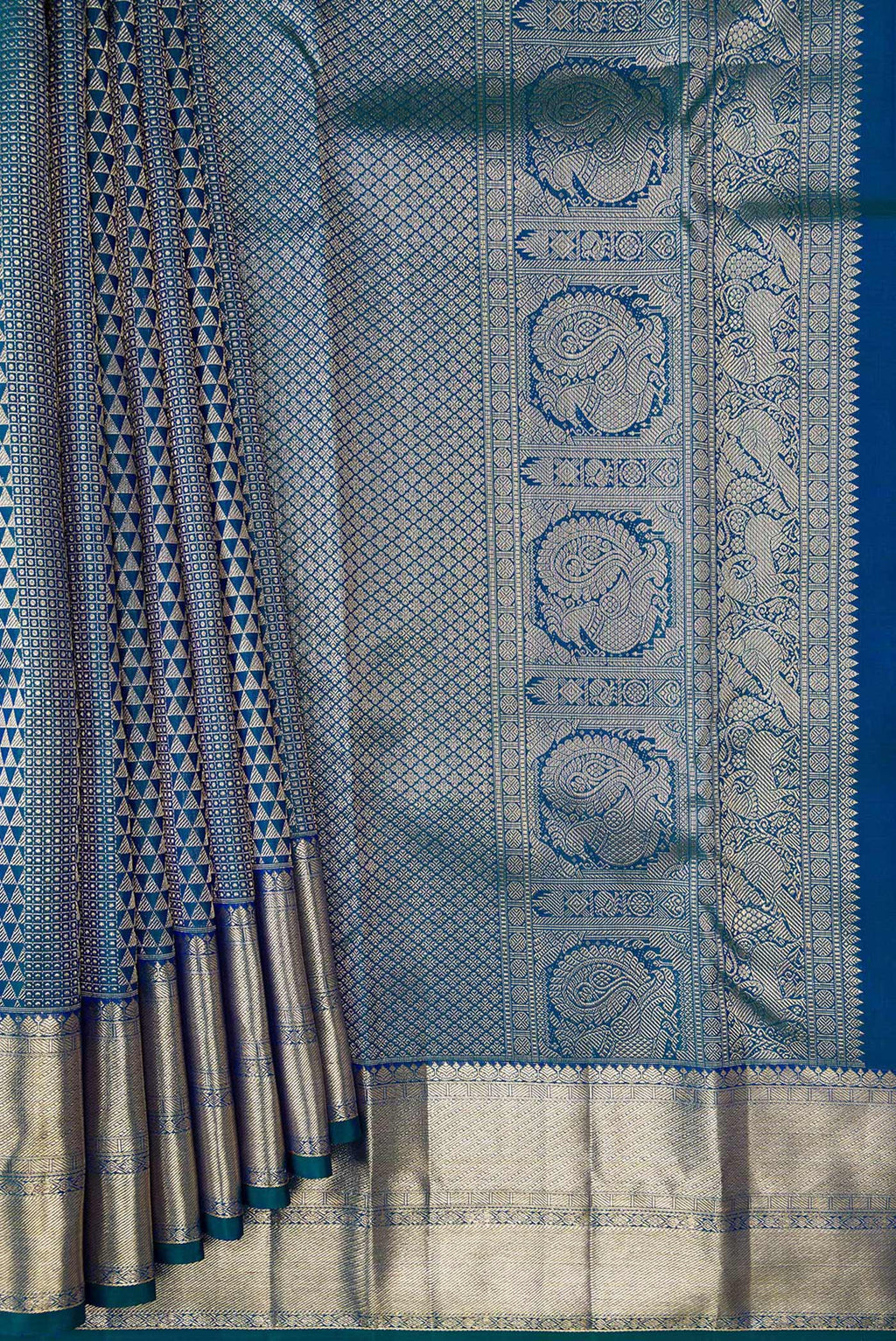 Pleats and pallu of Peacock Blue Dual Tone Kanchipuram Silk Saree with Zari Brocade on the body and Zari Border. 