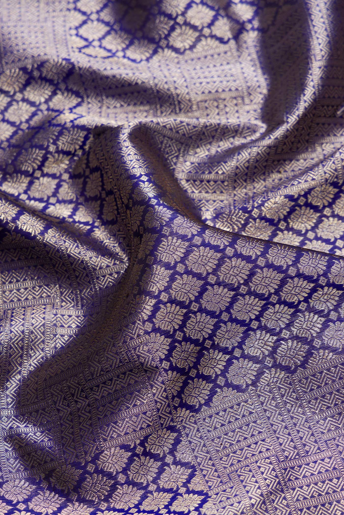 Close up of Royal Blue Dual Tone Kanchipuram Silk Saree with Zari Brocade on the body and Zari Border.  displaying folds
