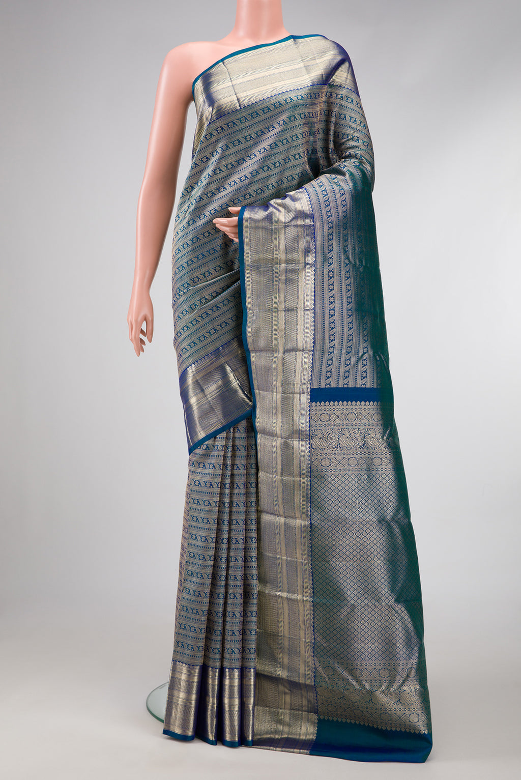 Peacock Blue Dual Tone Kanchipuram Silk Saree with Zari Brocade on the body and Zari Border.  displayed on a mannequin