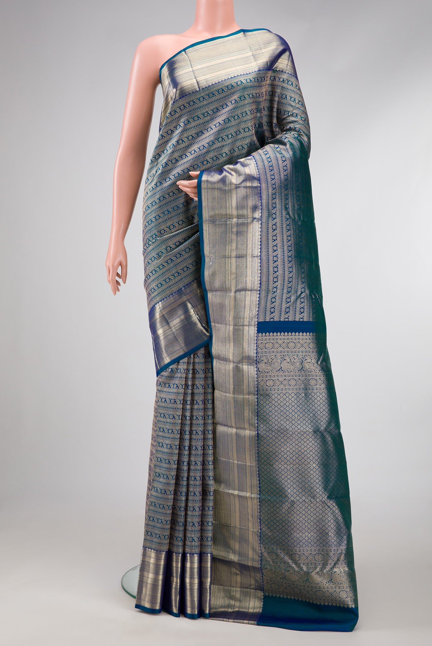 Peacock Blue Dual Tone Kanchipuram Silk Saree with Zari Brocade on the body and Zari Border.  displayed on a mannequin